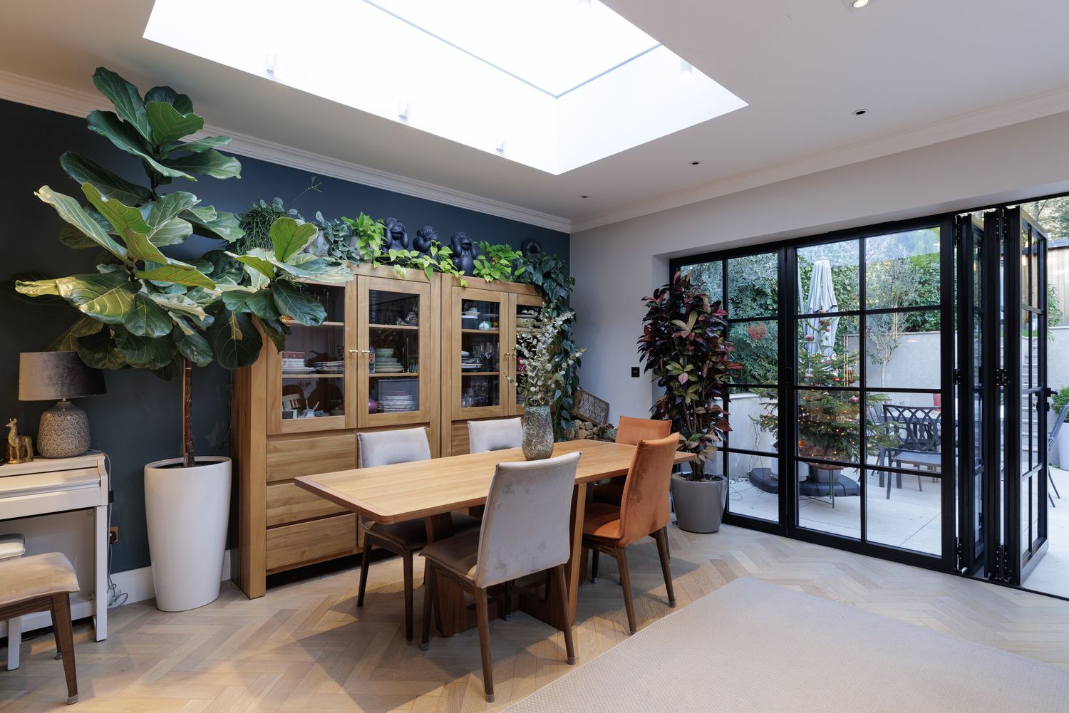 Dining area with oak table, house plants and a large rooflight