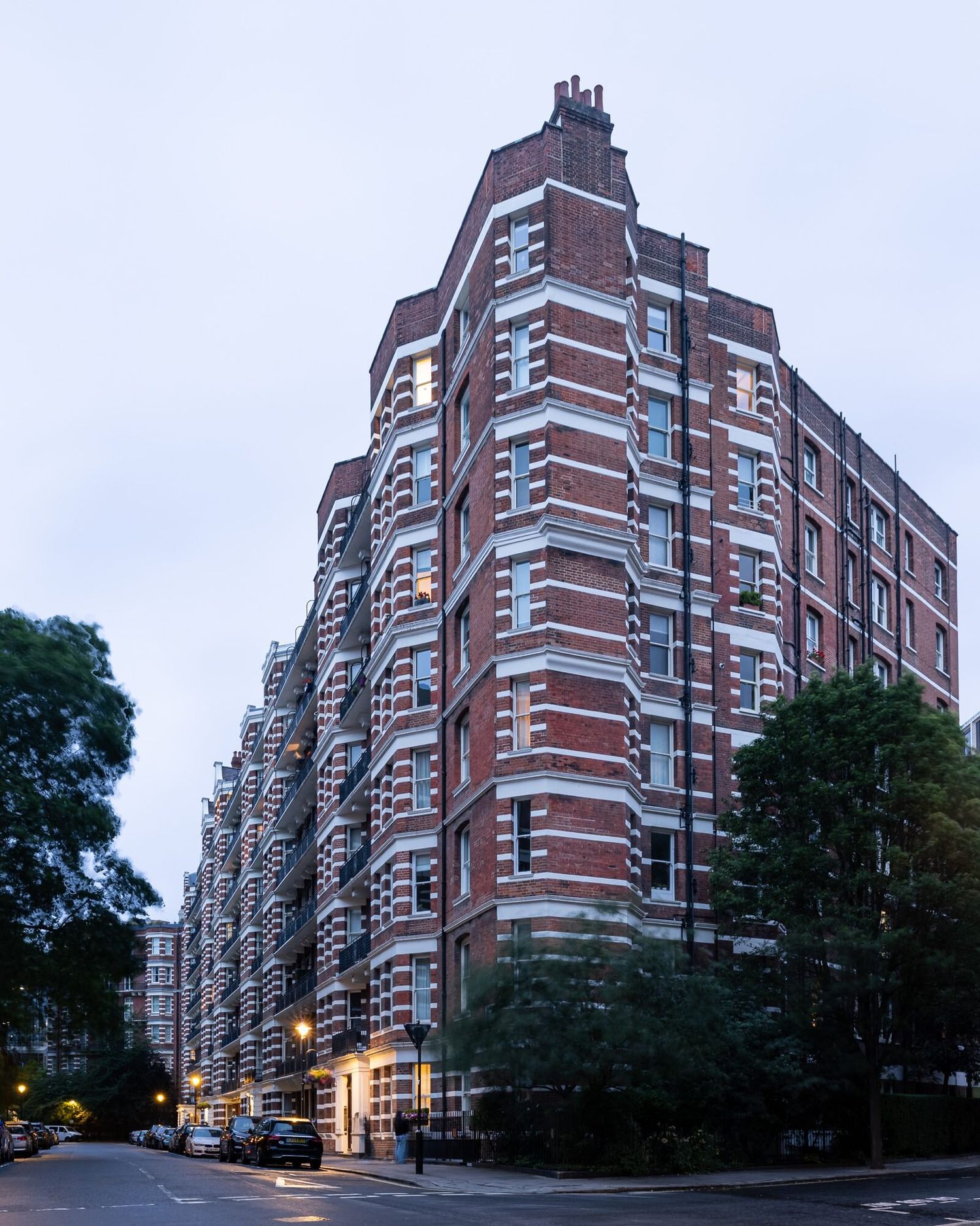 Red-brick mansion block at dusk in Westminster, London