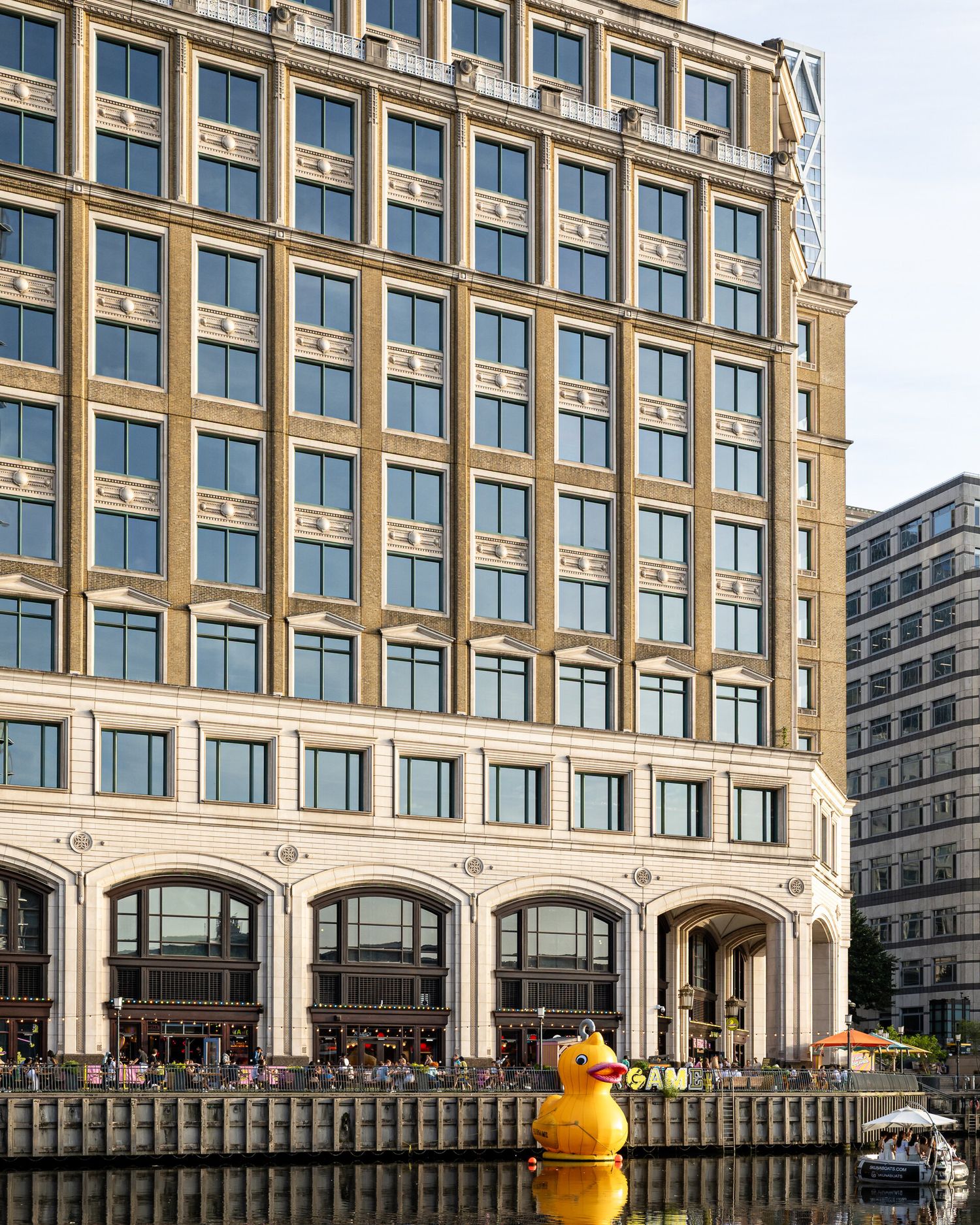 Classical-style office building beside the water at Canary Wharf, London