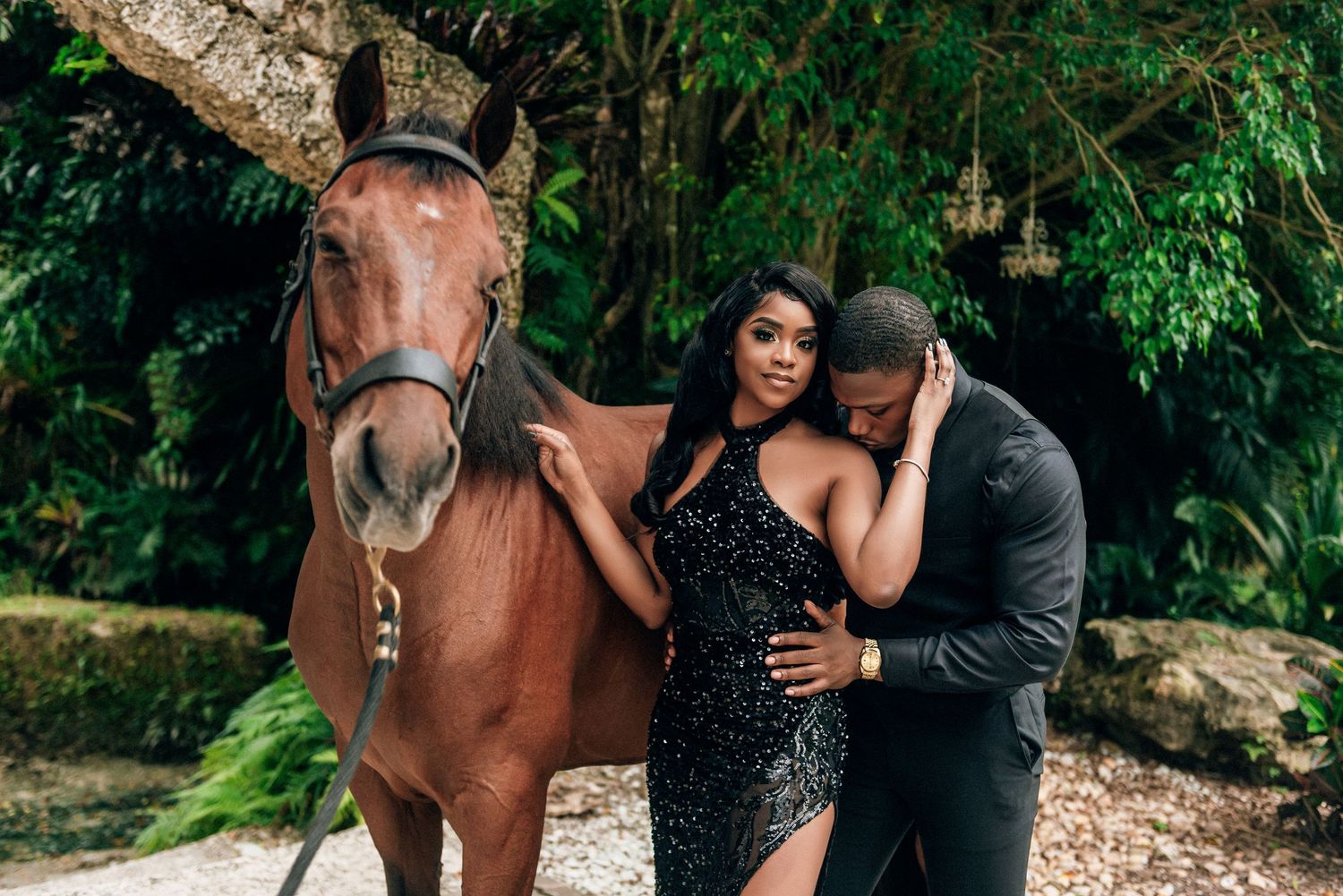 Romantic engagement photo session in a lush forest setting with a brown horse as a special guest.