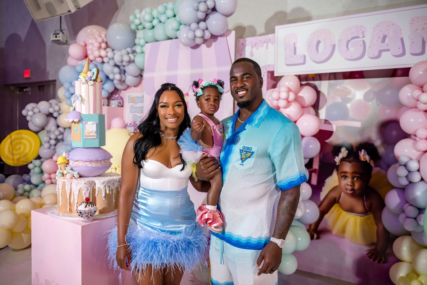 Family celebration with pastel balloon decor and custom cake display.
