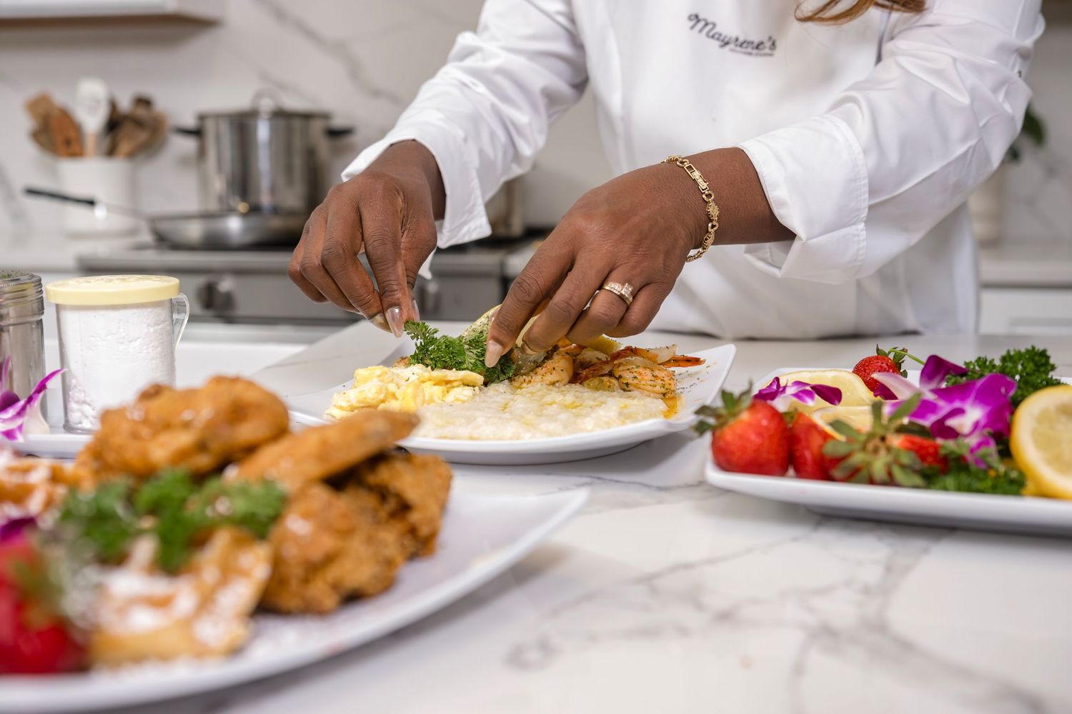 Professional chef in white coat plates gourmet dishes in upscale restaurant kitchen.