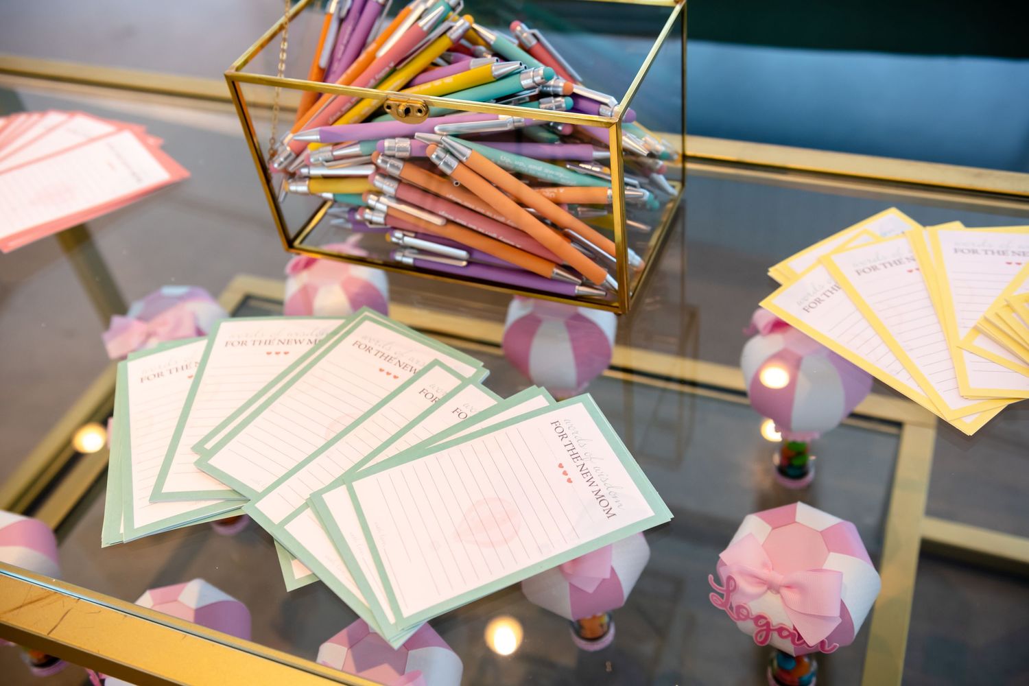 A collection of colorful greeting cards and envelopes arranged in a neat display on a reflective surface.