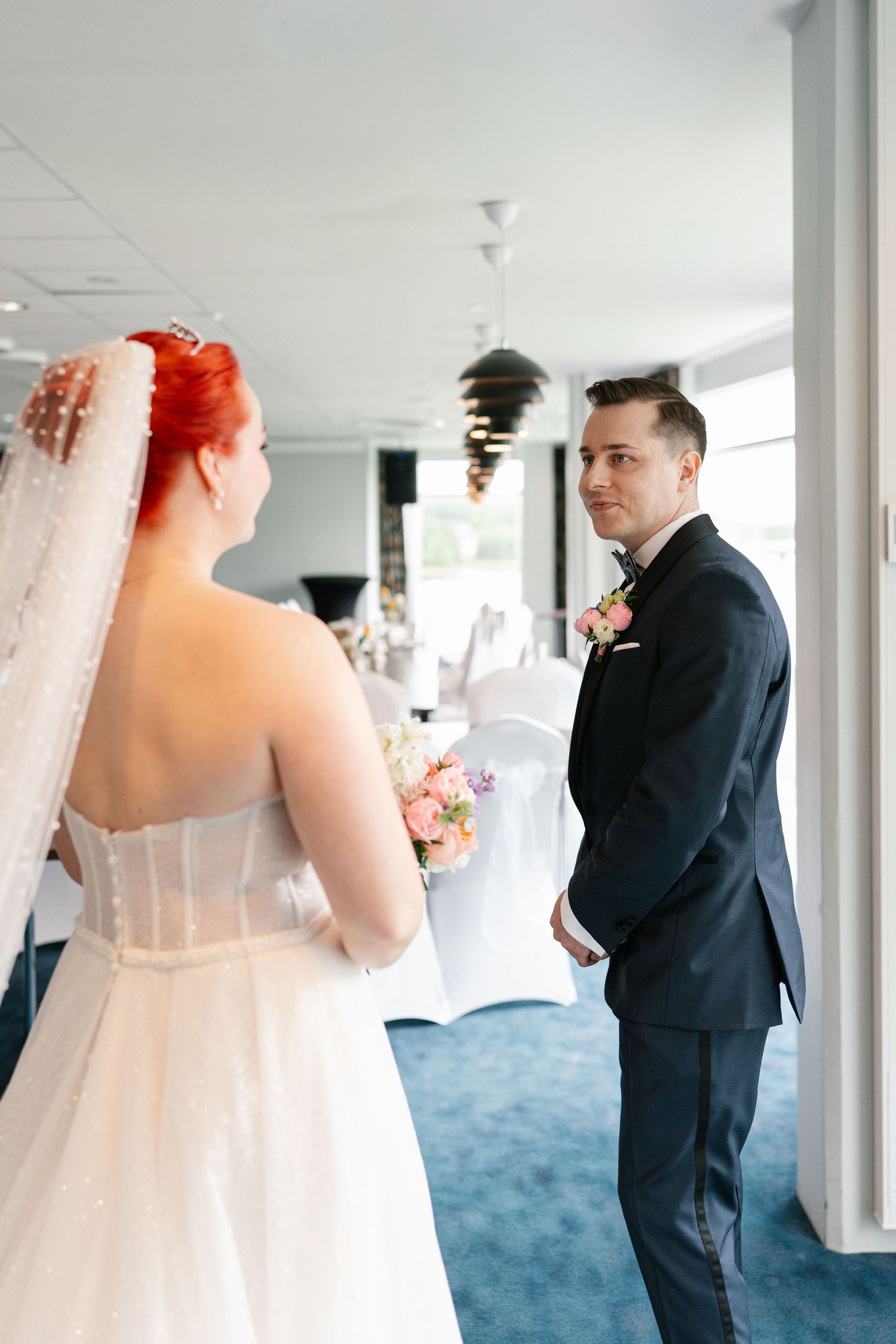 Emotional first look wedding moment captured in sequence in modern indoor setting.