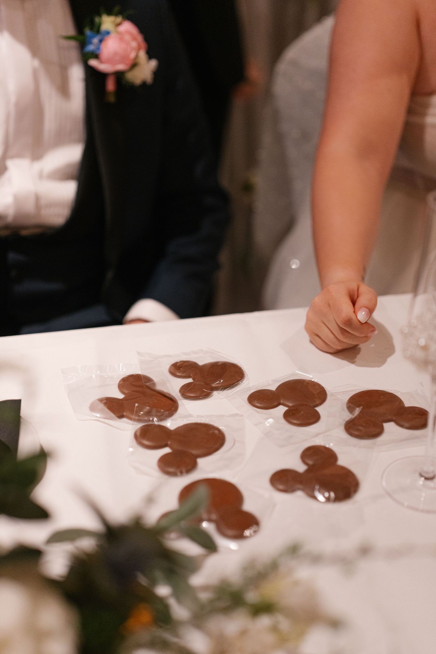 Chocolate gingerbread cookies arranged on white tablecloth at wedding reception.