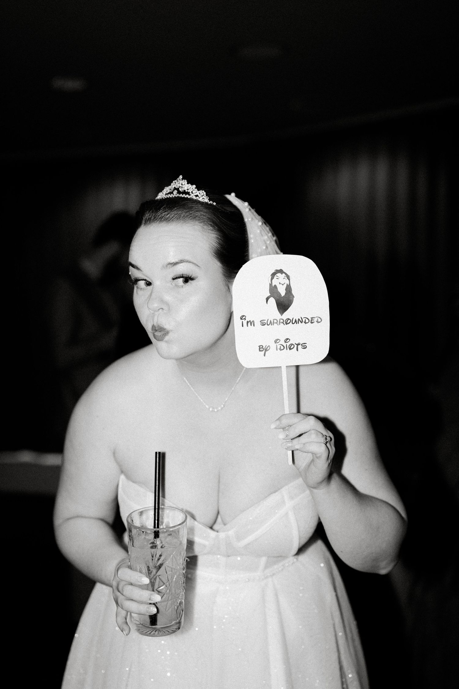 Wedding reception candid moment with drinks and props.