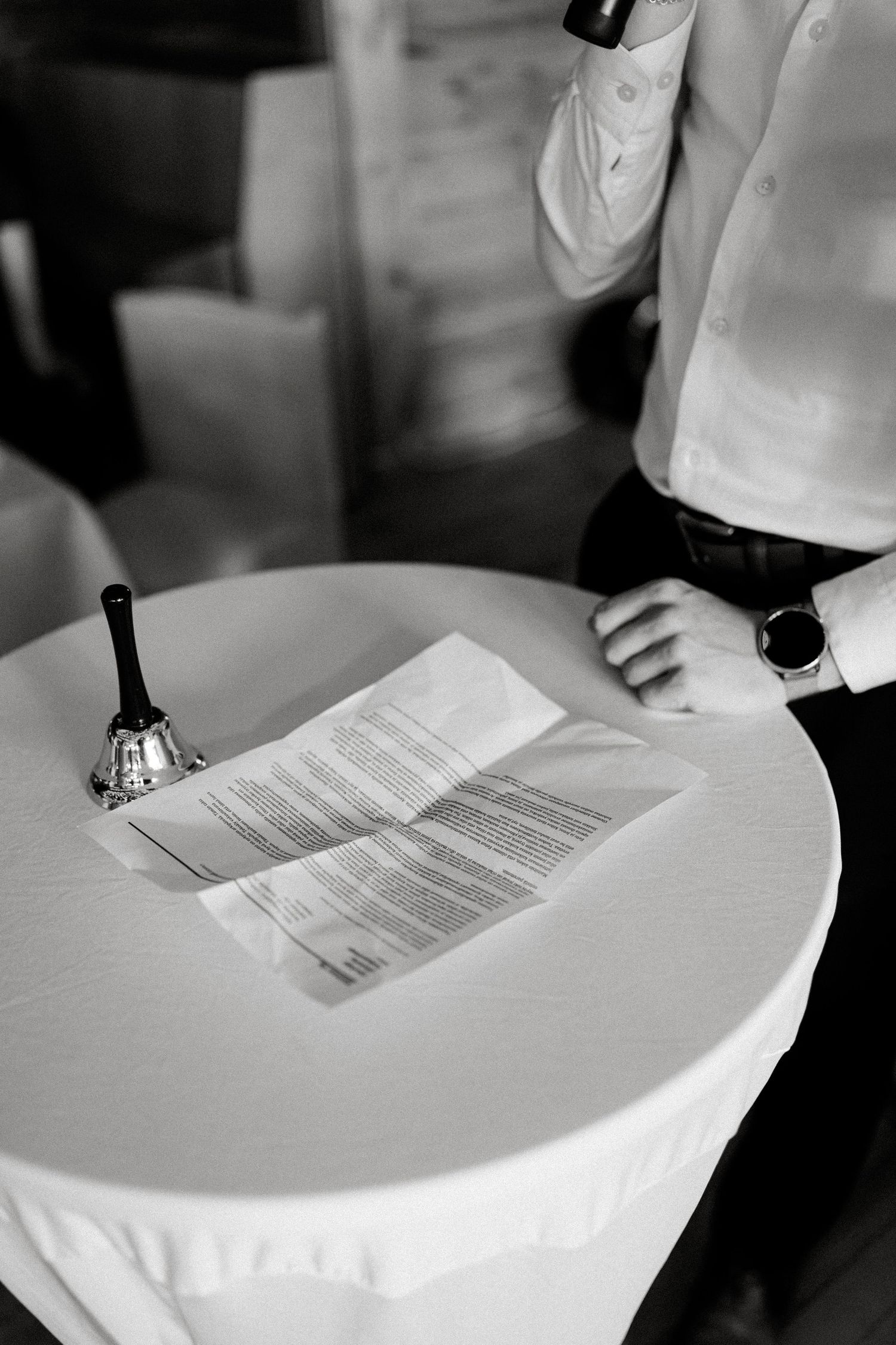 Documents and papers laid out on a white tablecloth at a formal event.