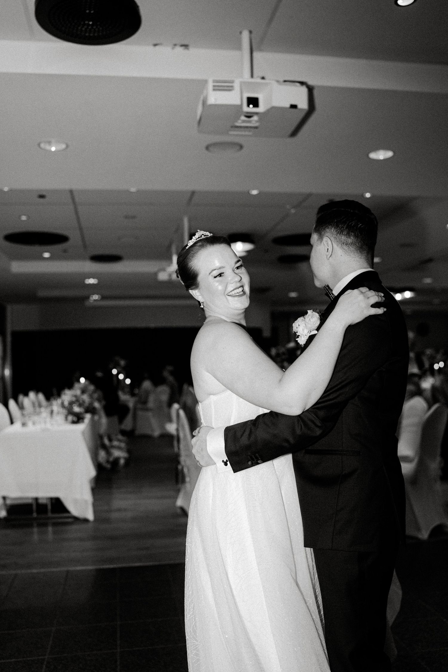 Black and white photos capturing dance movements at an indoor wedding reception.