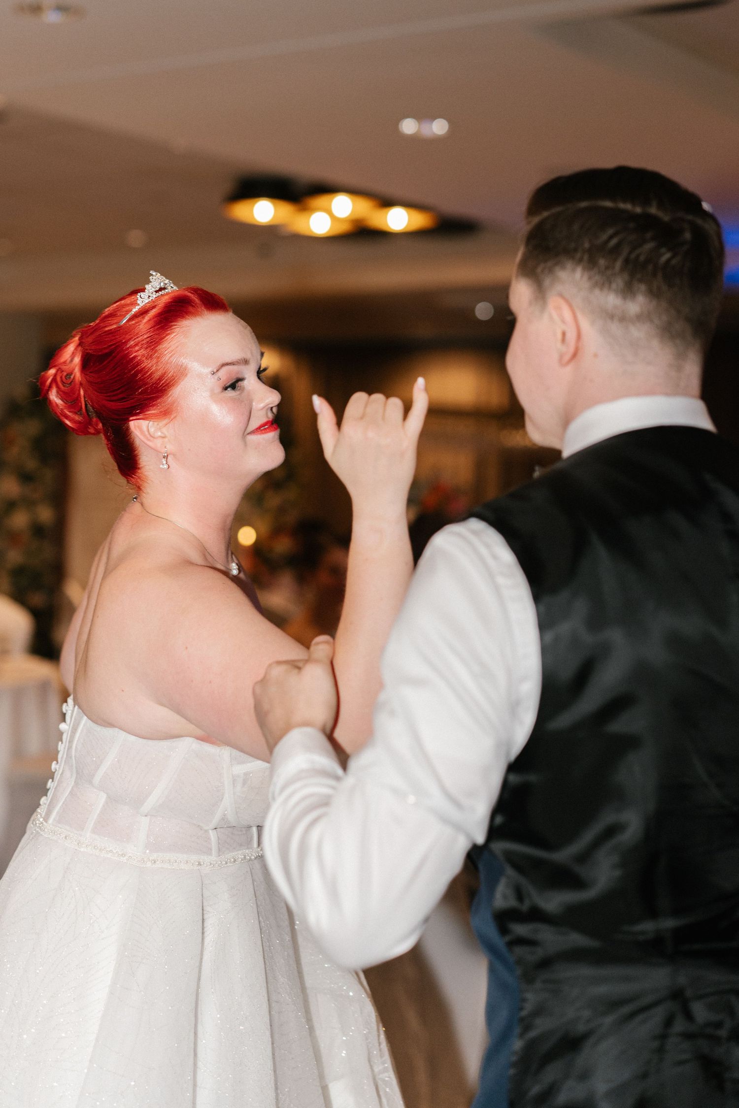 A couple shares a romantic dance moment at their wedding reception.