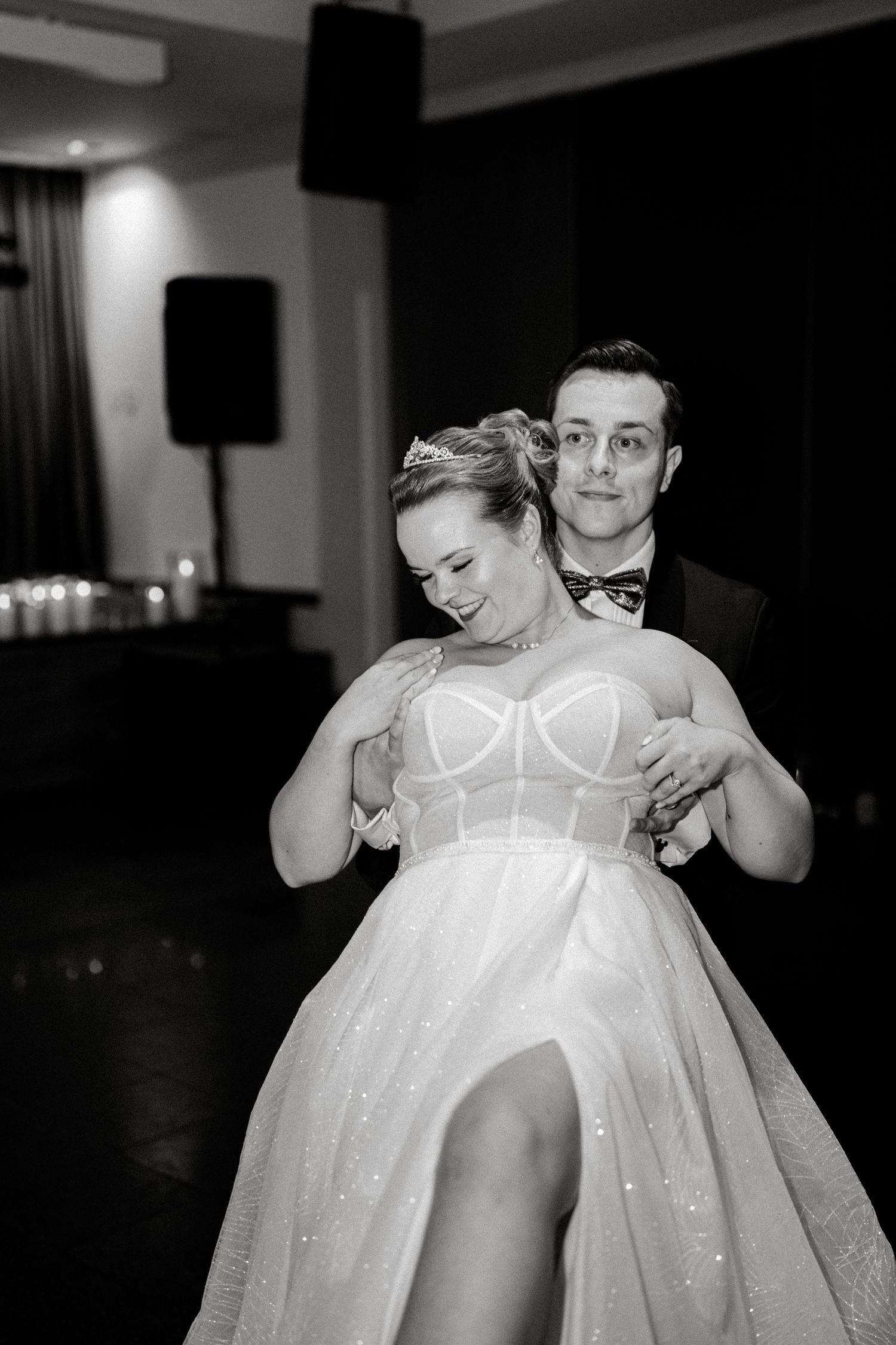 Black and white photos showing intimate dance moments at an indoor wedding reception.