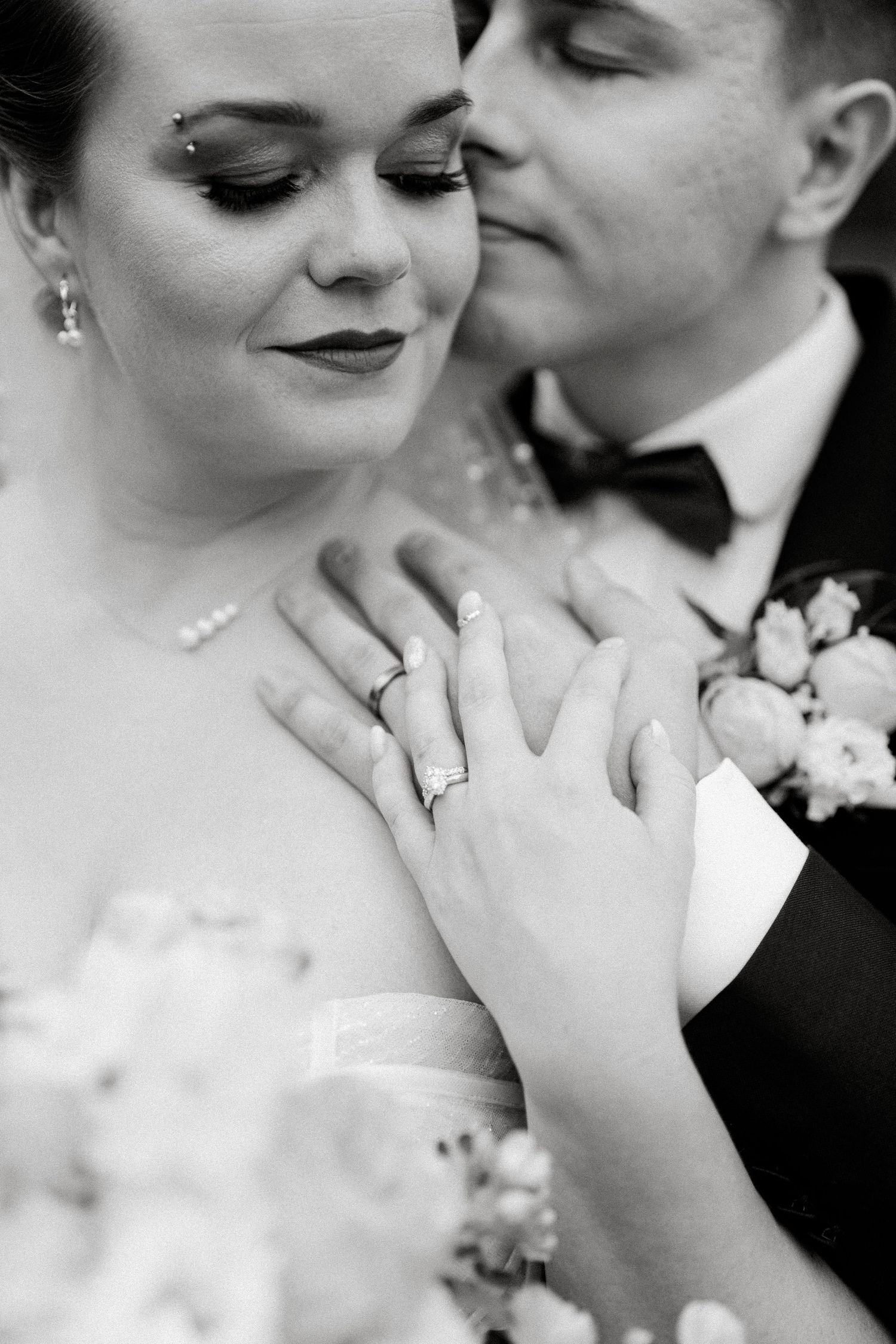Close-up black and white wedding photos showing tender romantic moments and a beautiful bouquet.