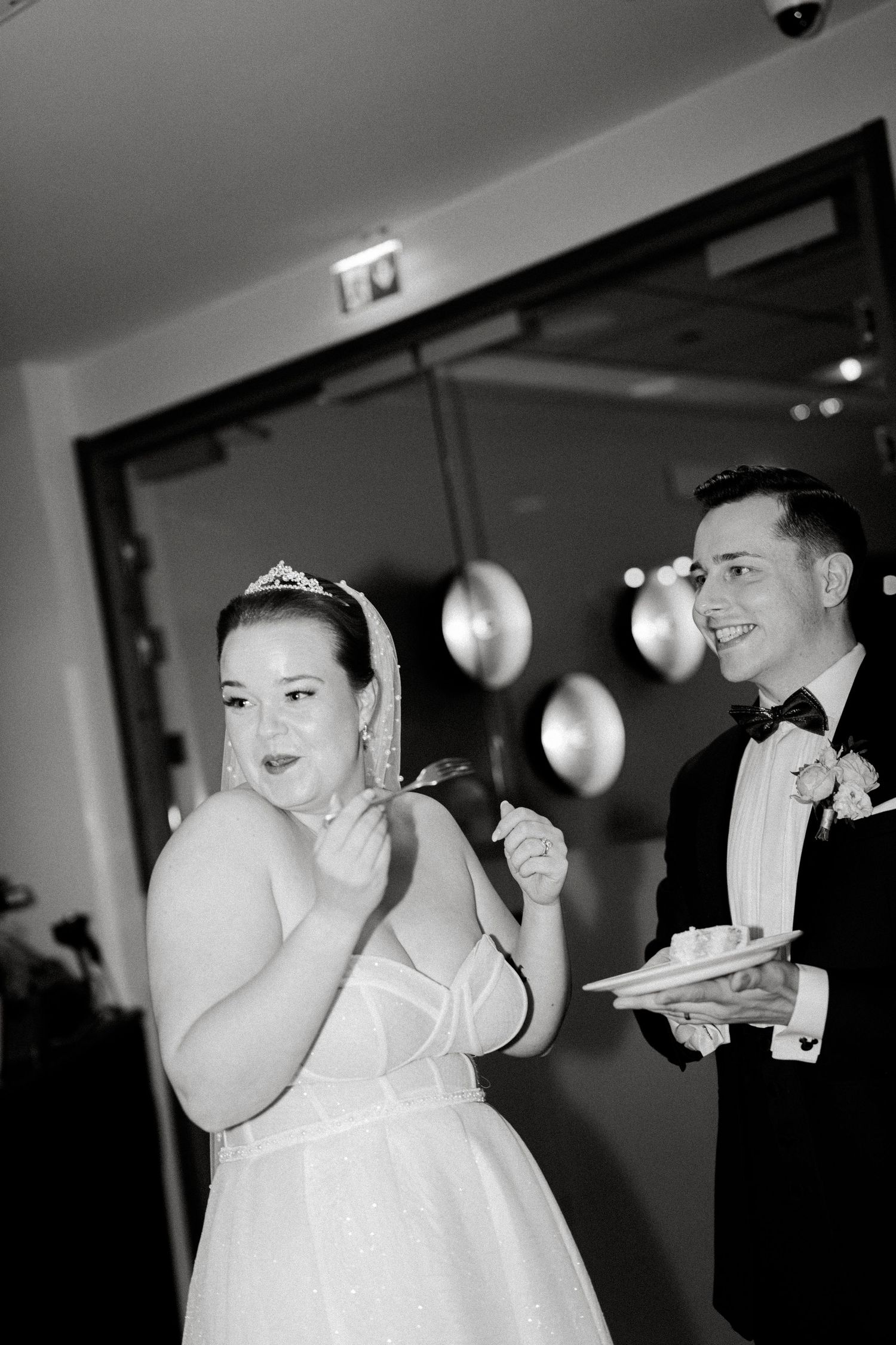 Series of candid black and white photos capturing joyful reactions during a wedding reception.
