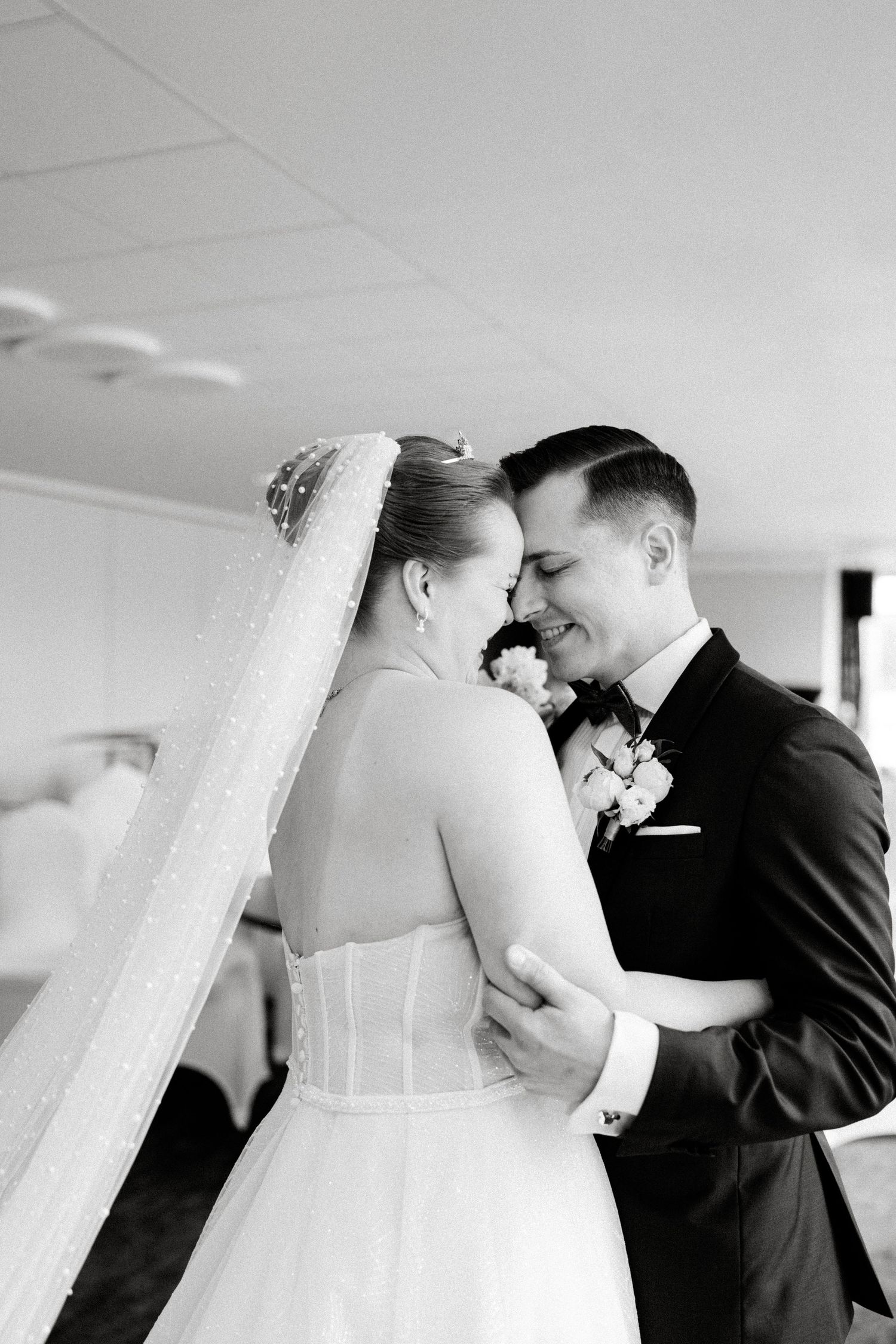 Black and white sequence of tender first look moment between newlyweds.