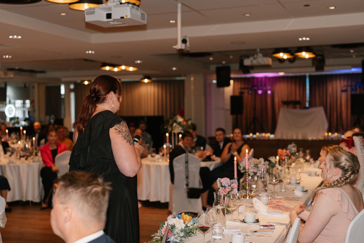Large wedding reception hall with tables and chairs set up for guests.