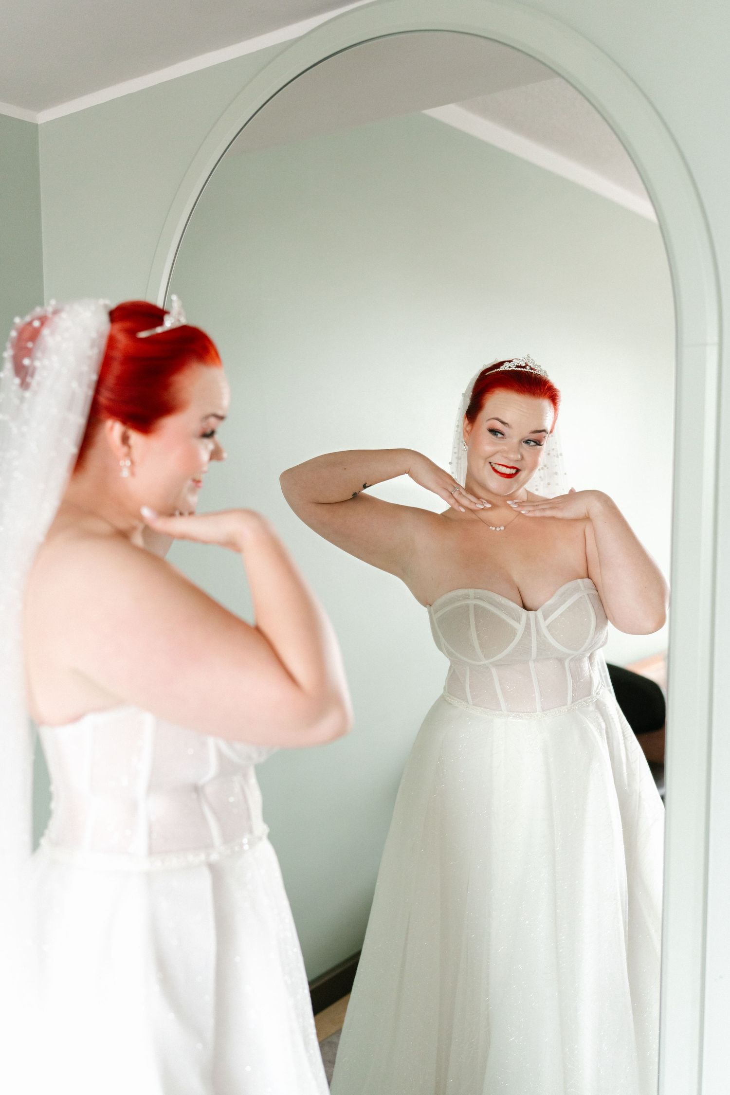 A series of mirror reflections show a wedding dress being styled in a mint-colored room.