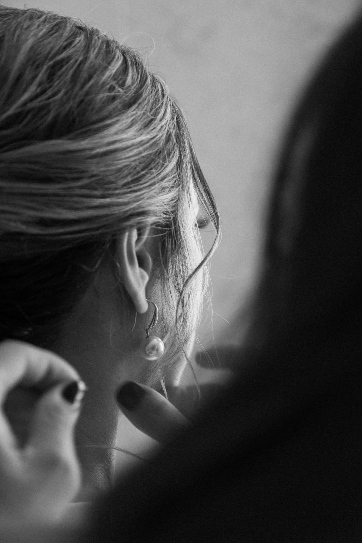 Artistic black and white close-up of a woman’s profile, highlighting soft lighting and delicate hair details.