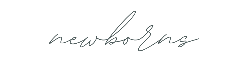 A handwritten cursive signature in black ink appears on a white surface.