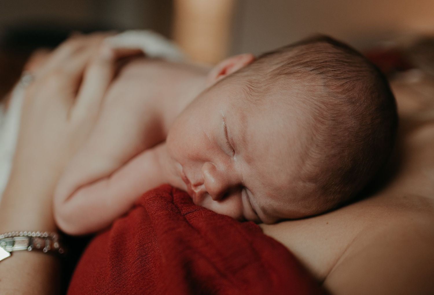 a close up of a new-born's face, sleeping