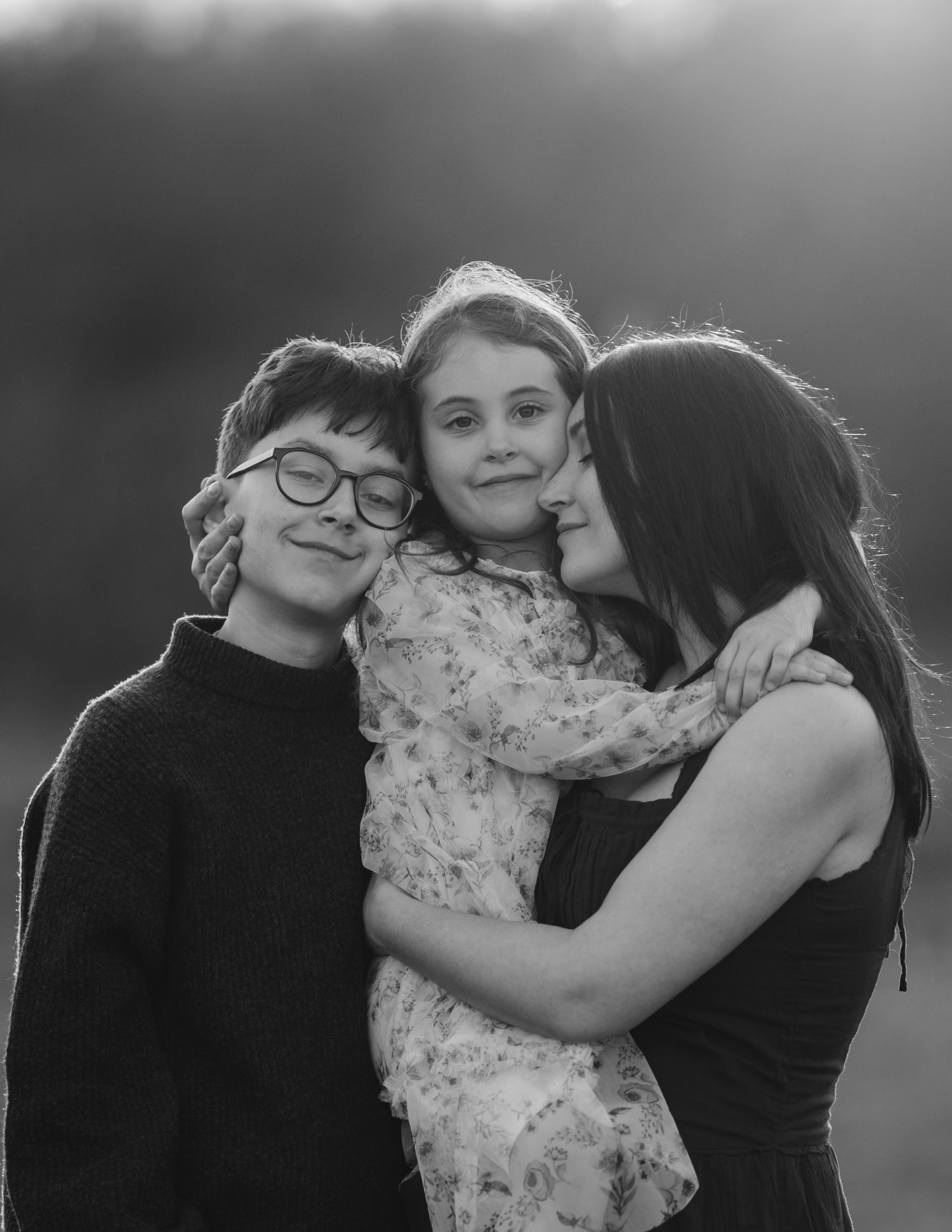A mother hugging her son and daughter, kent family photographer
