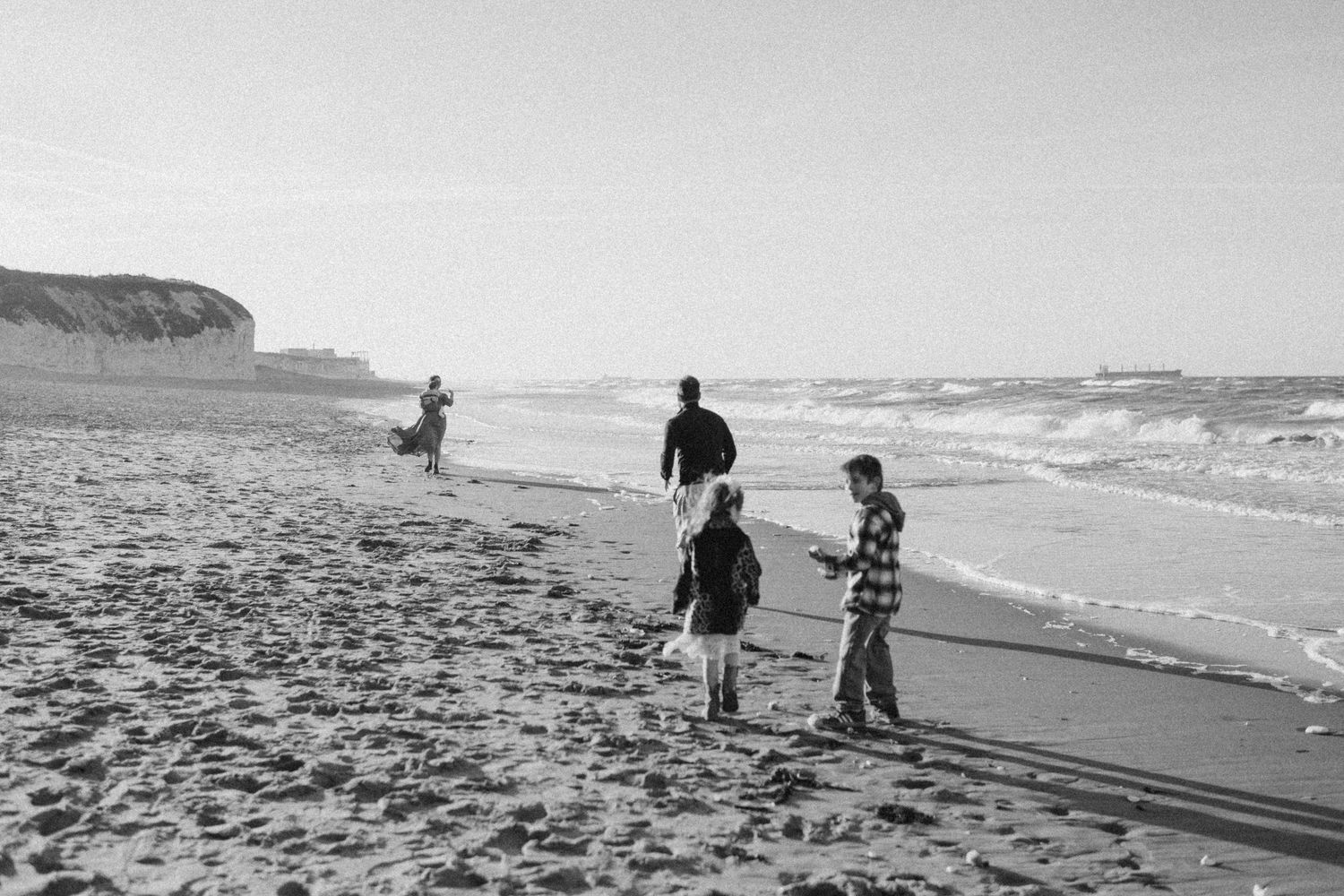 A candid photo of a family walking on a beach