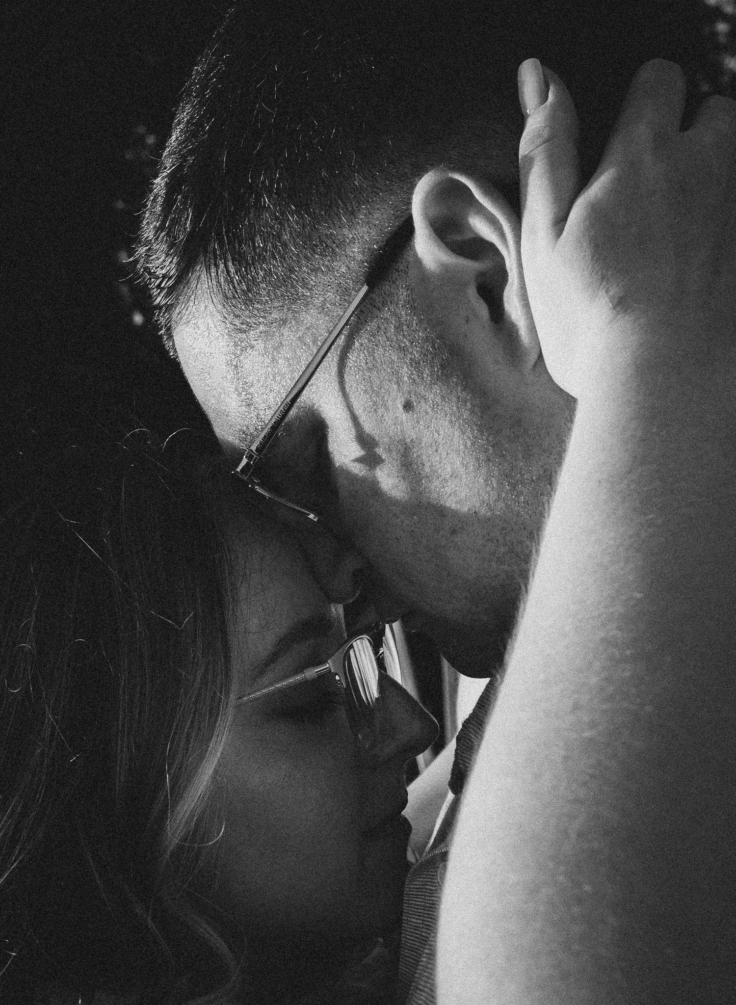 An intimate black and white close-up portrait capturing a tender moment.