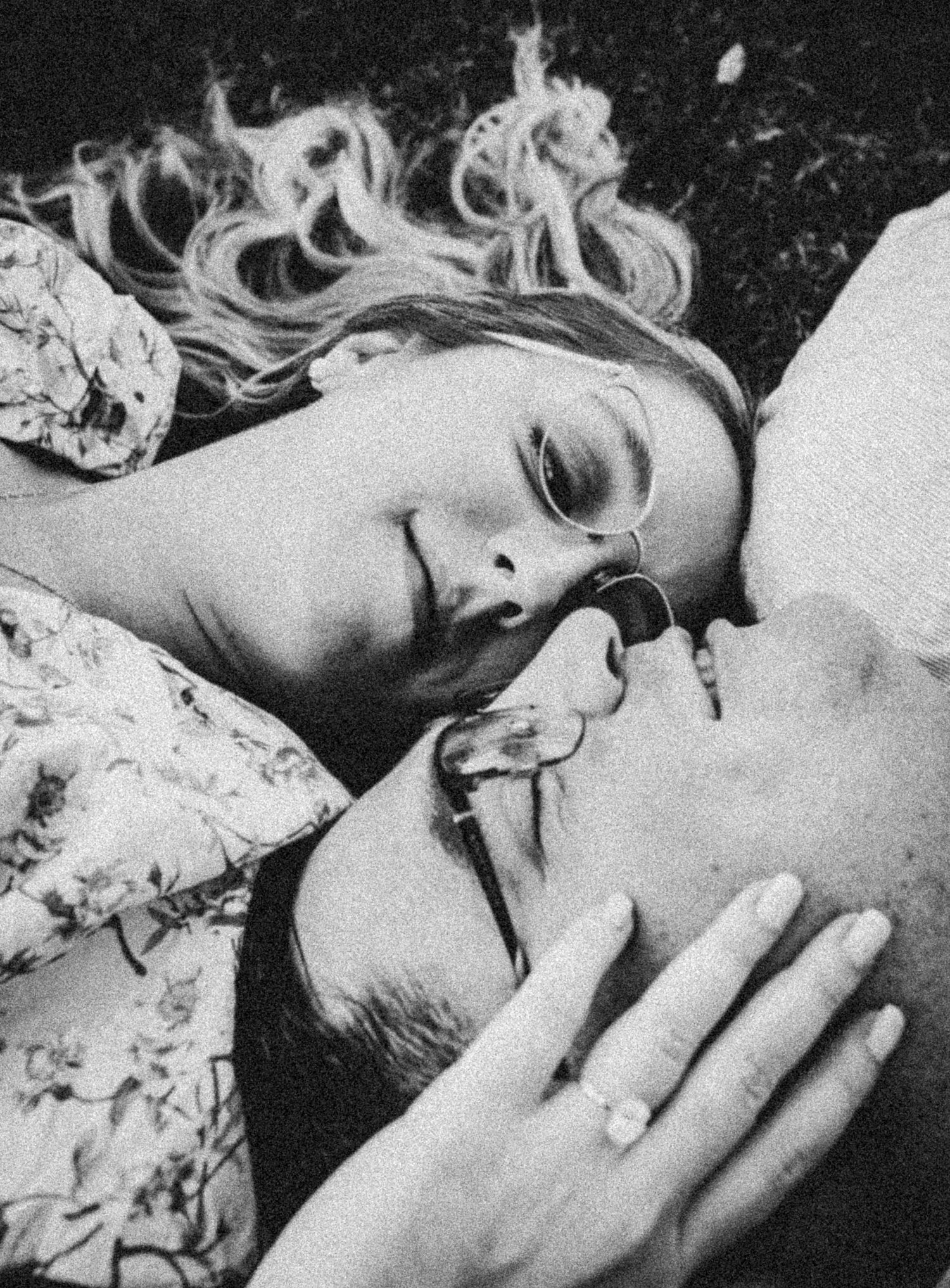 A black and white intimate portrait of a couple in a tender moment.