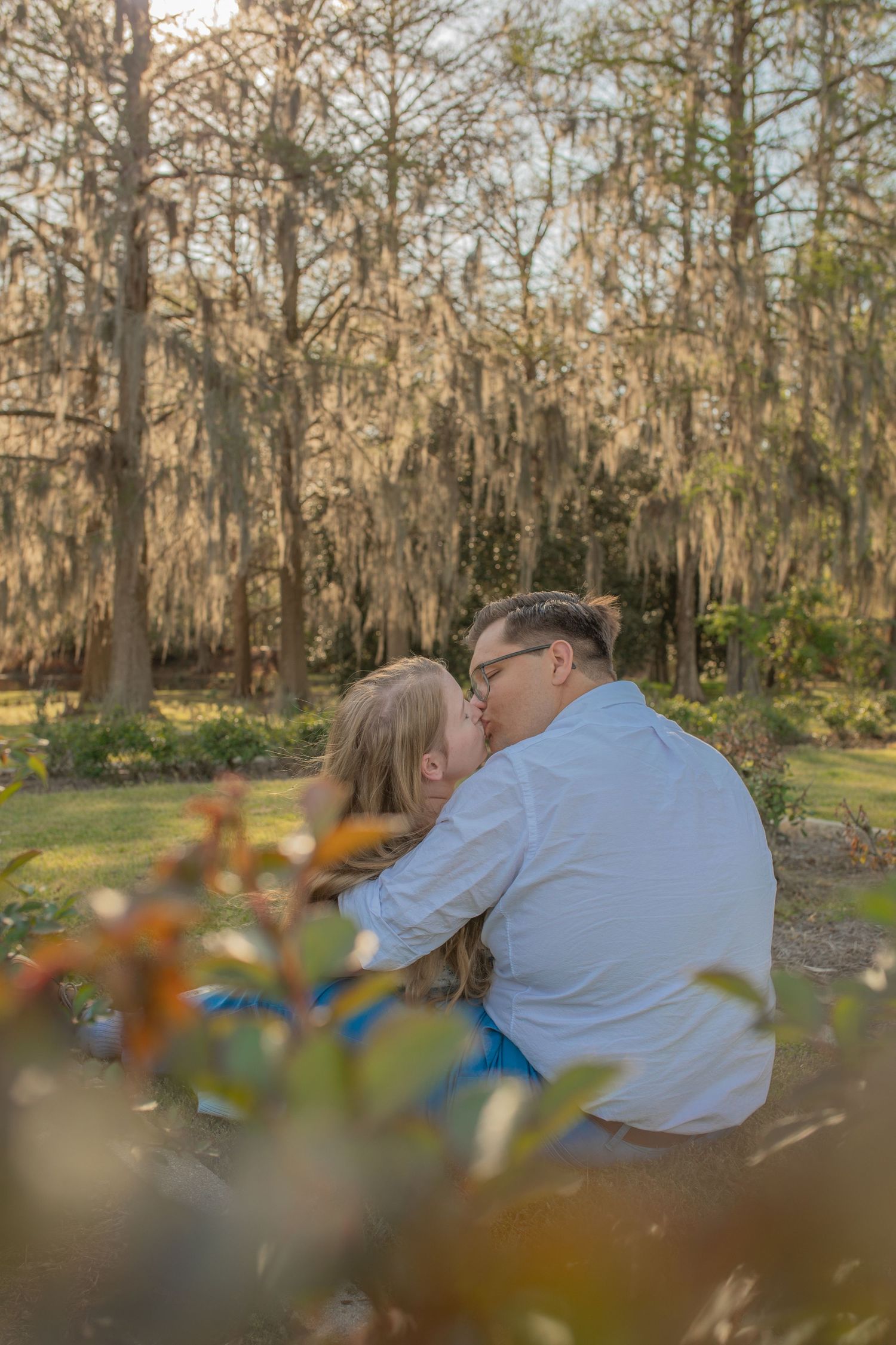 A romantic autumn scene in a Spanish moss-draped garden with cypress trees creating a dreamy backdrop.