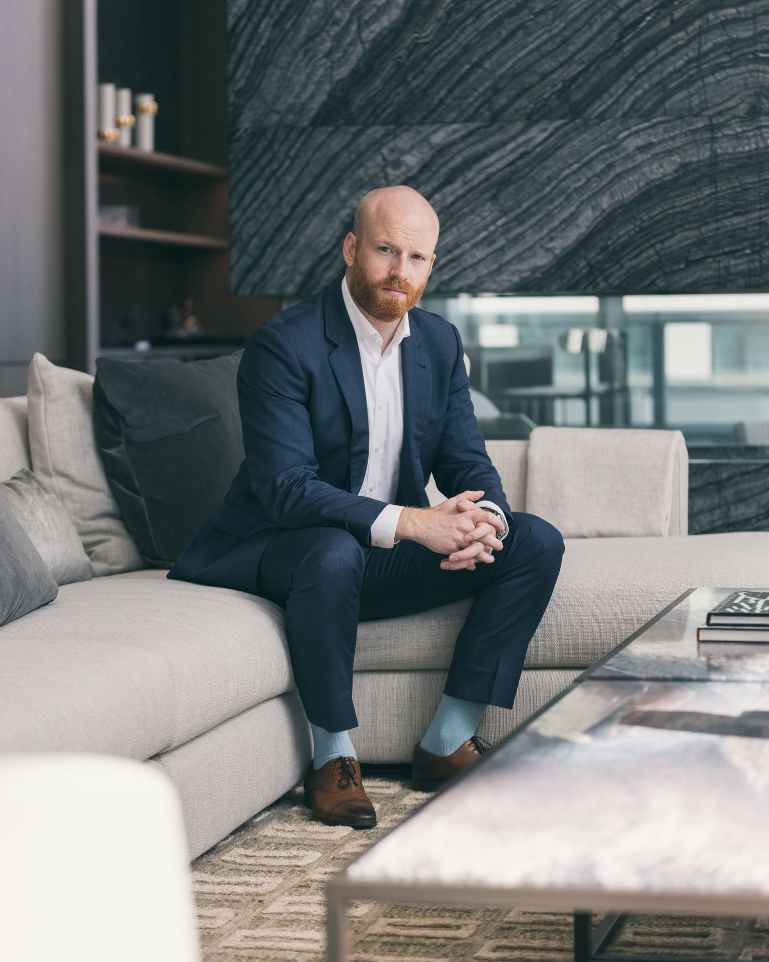 Professional portrait session in modern office space with minimalist gray decor.