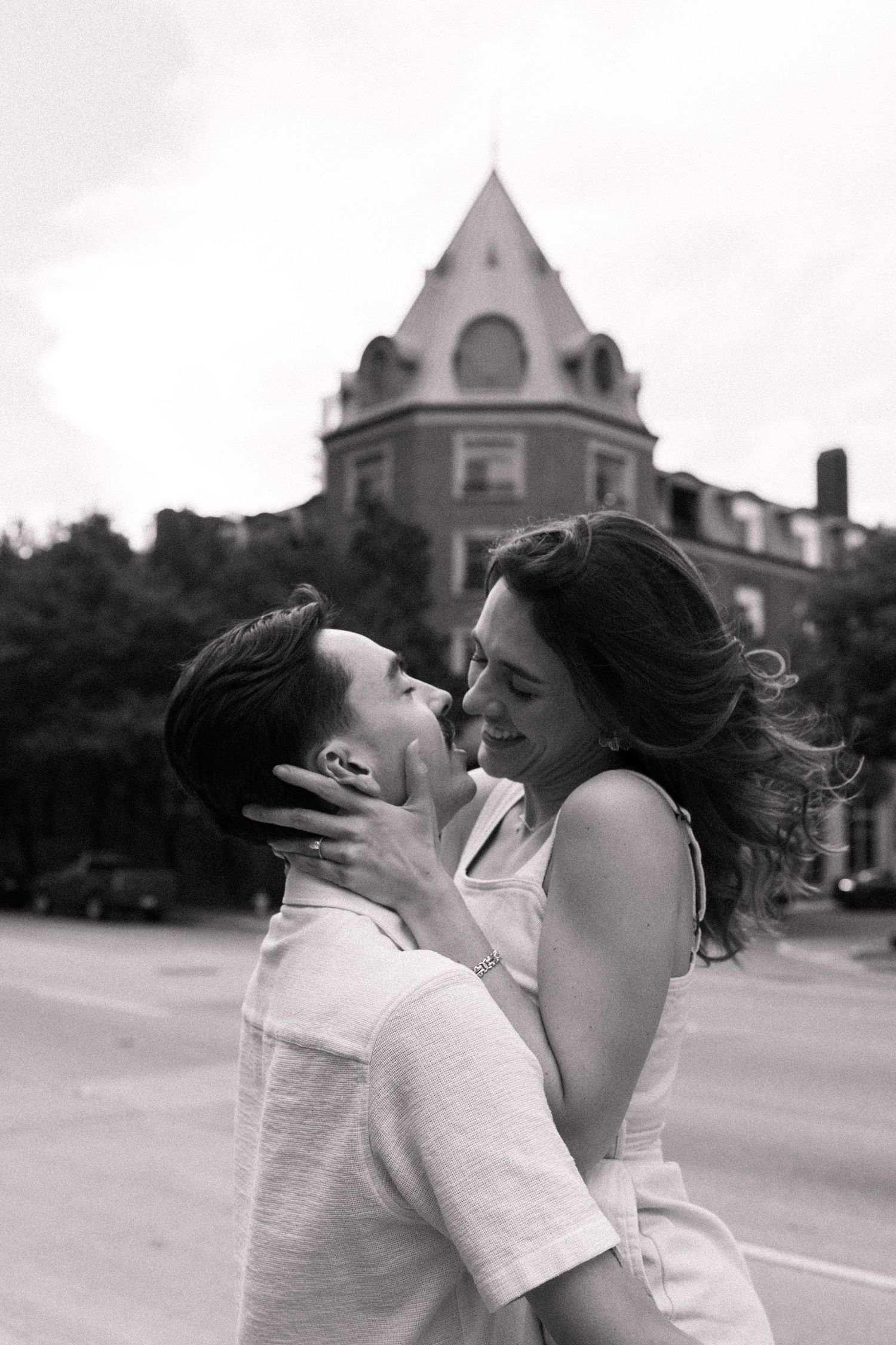 A romantic black and white photo sequence shows a couple sharing a passionate kiss on a street with buildings in the background.