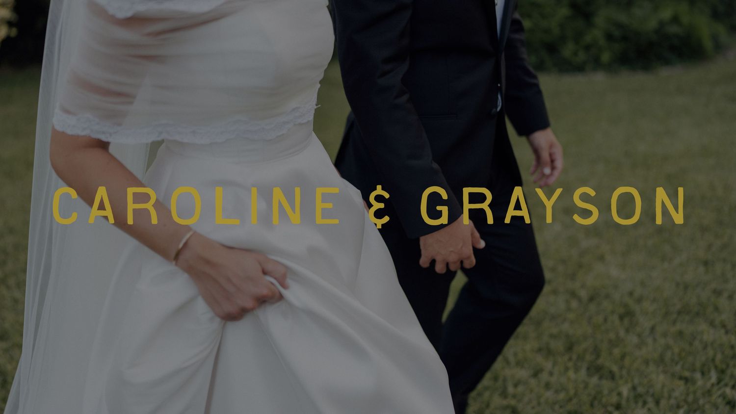 Caroline and Grayson wedding video still showing bride in white gown and groom in dark suit holding hands outdoors.