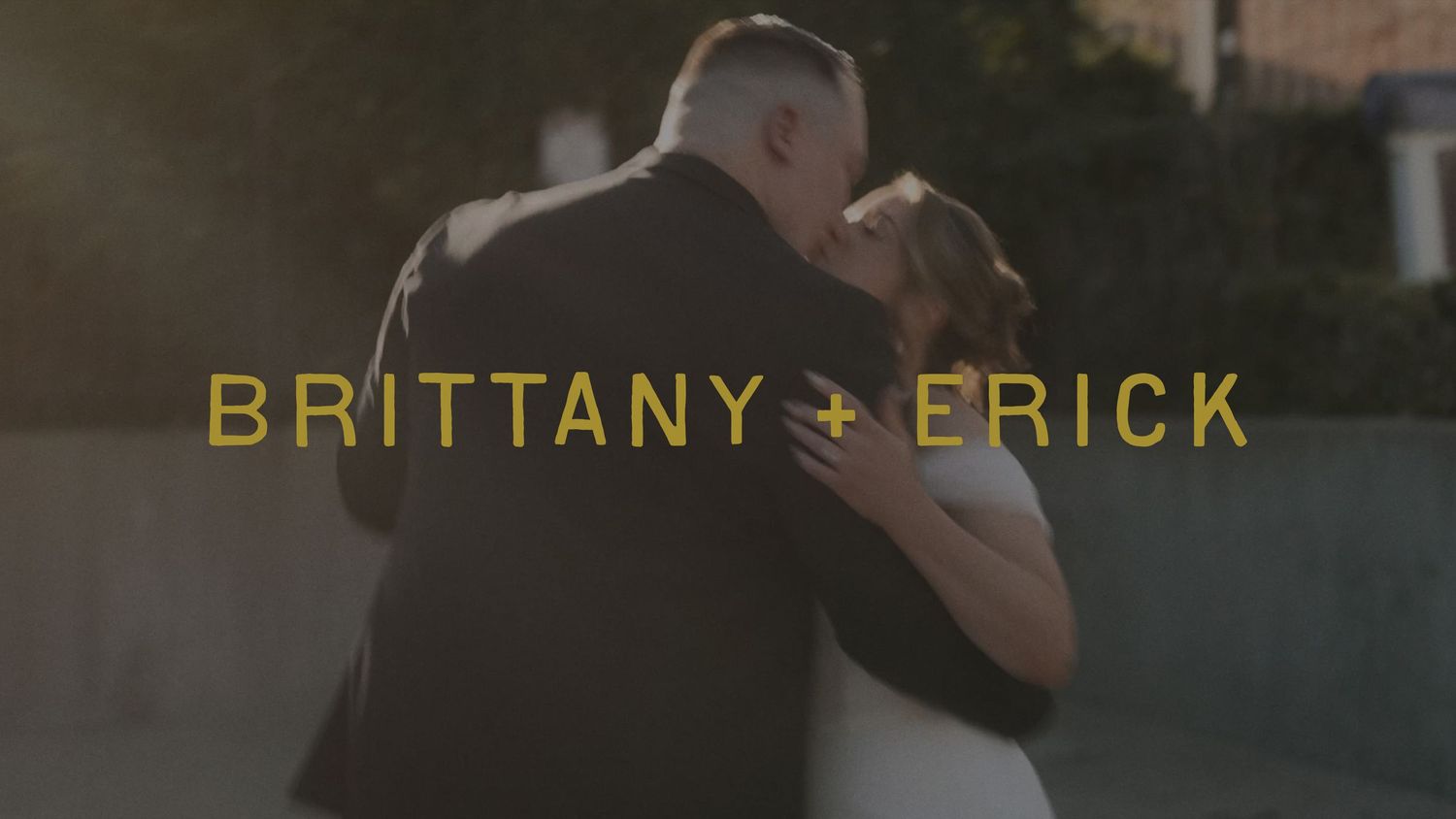 Brittany and Erick share a romantic wedding dance, silhouetted against a warm golden sunset backdrop.