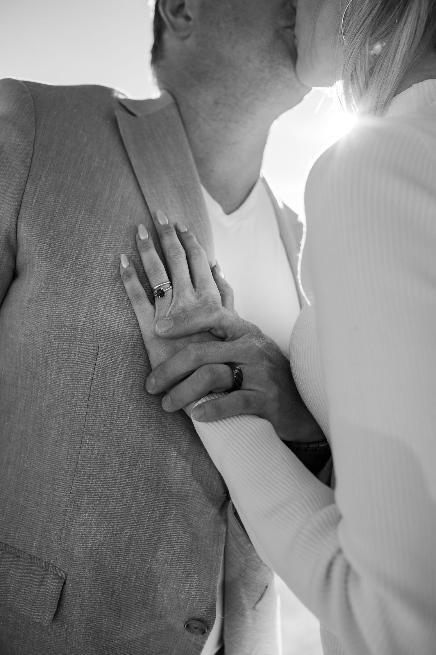 Artistic black and white close-up shots of couple's tender embraces.