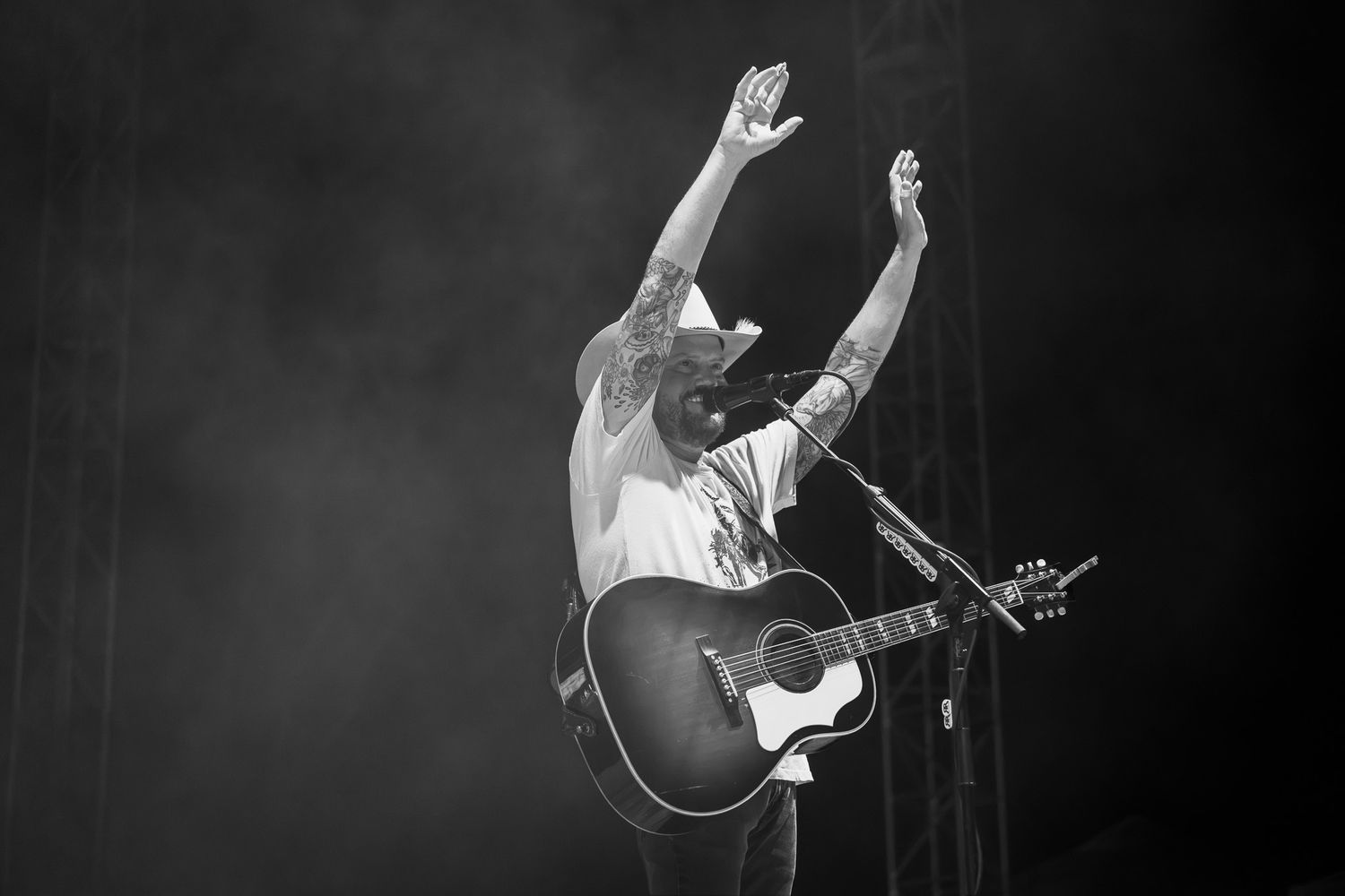 Black and white concert photo of Randy Rogers performing live with an acoustic guitar at Round Rock Amphitheater in Texas.