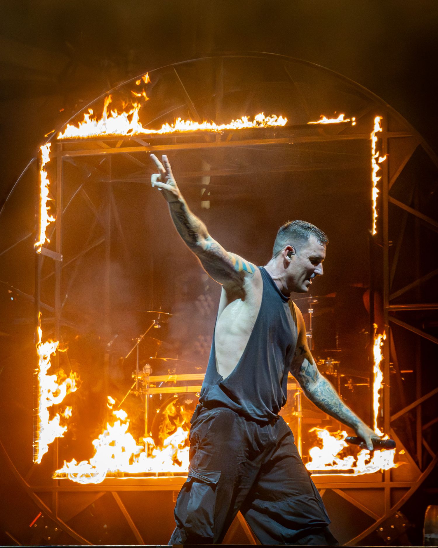 Parkway Drive Winston McCall performing in front of a massive fire pyrotechnic display at Germania Insurance Amphitheater in Austin, Texas.