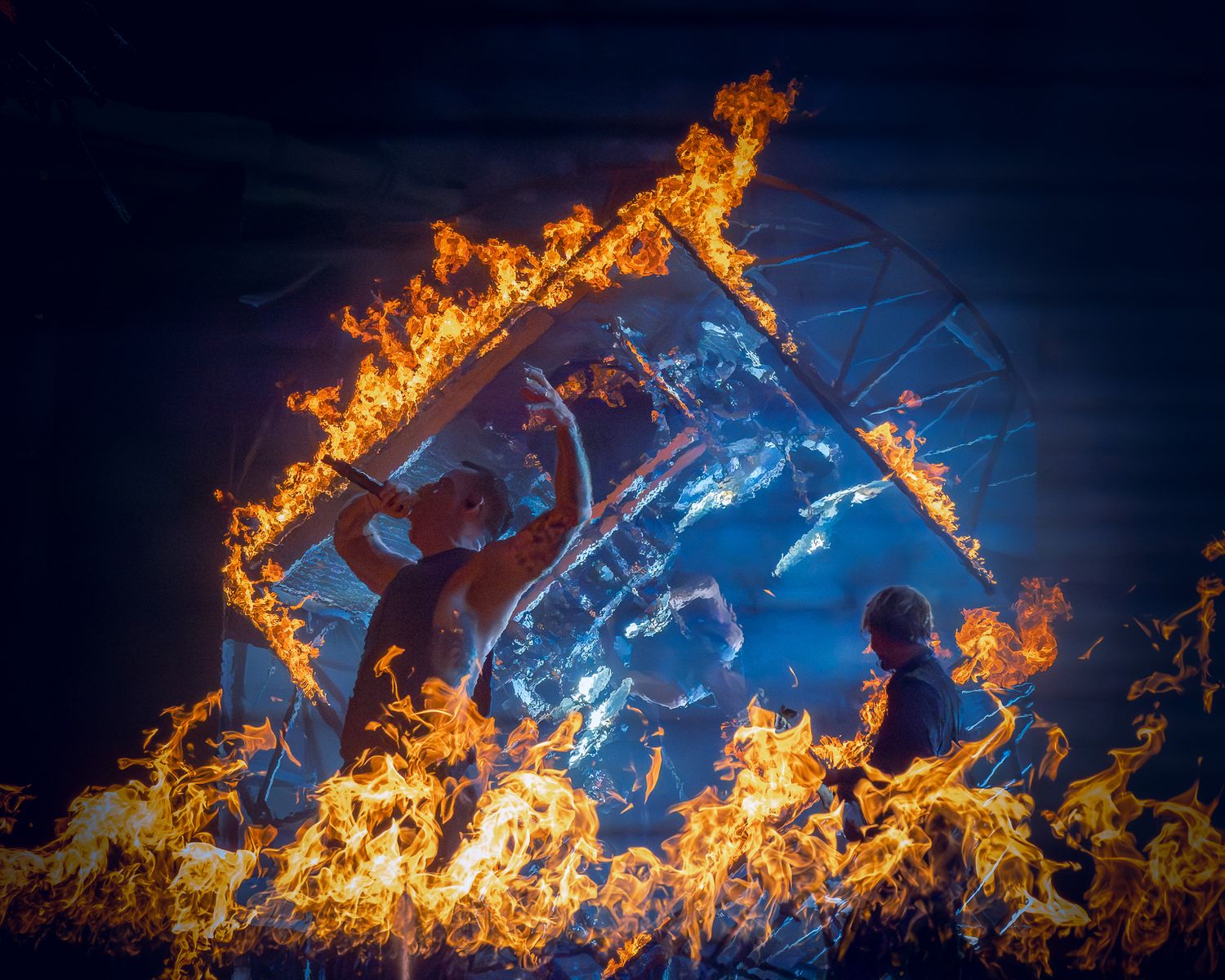Parkway Drive Winston McCall performing surrounded by dramatic flames and pyrotechnics at Germania Insurance Amphitheater in Austin, Texas.