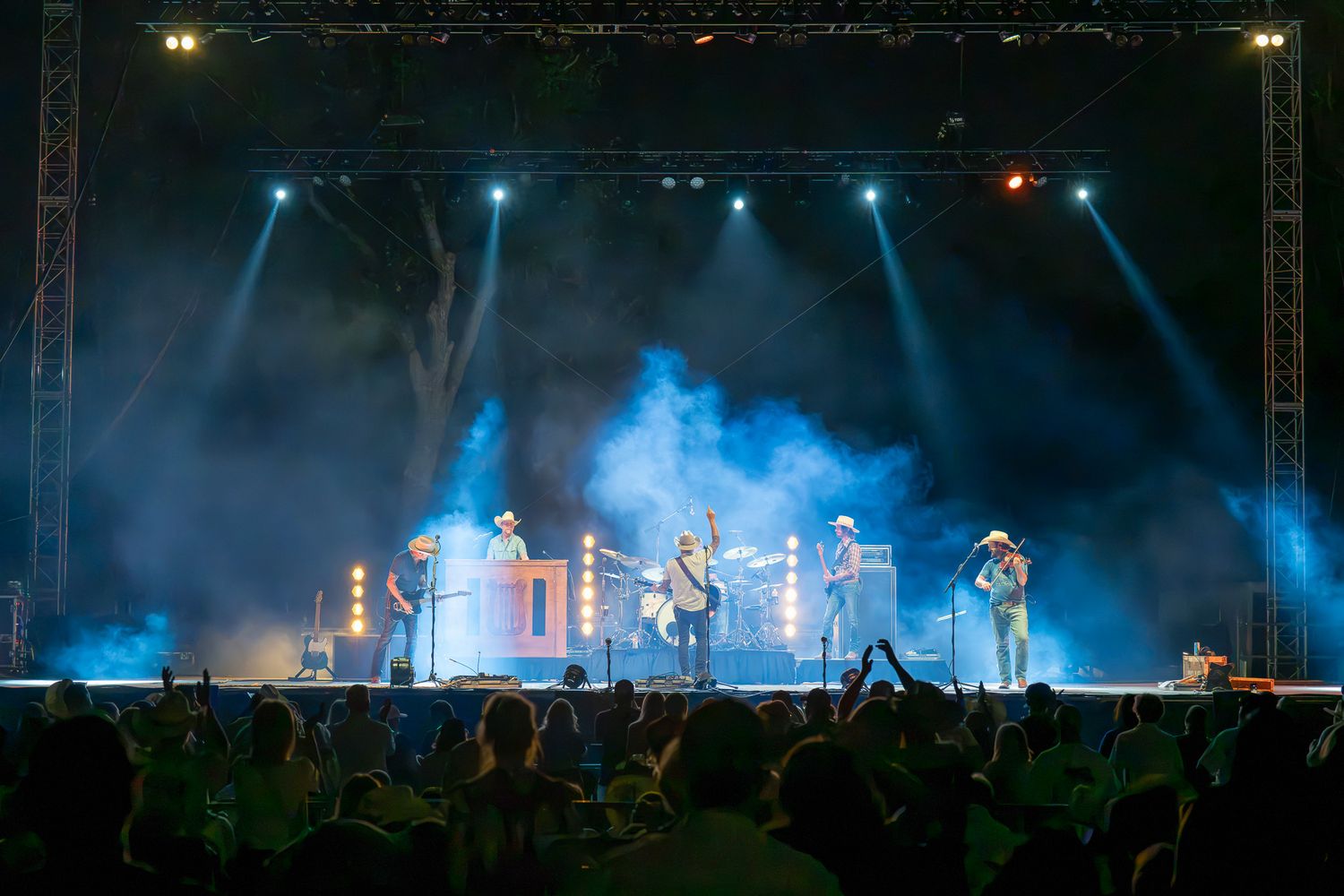 Randy Rogers Band performing live at Round Rock Amphitheater near Austin, Texas, surrounded by blue stage lights and smoke.