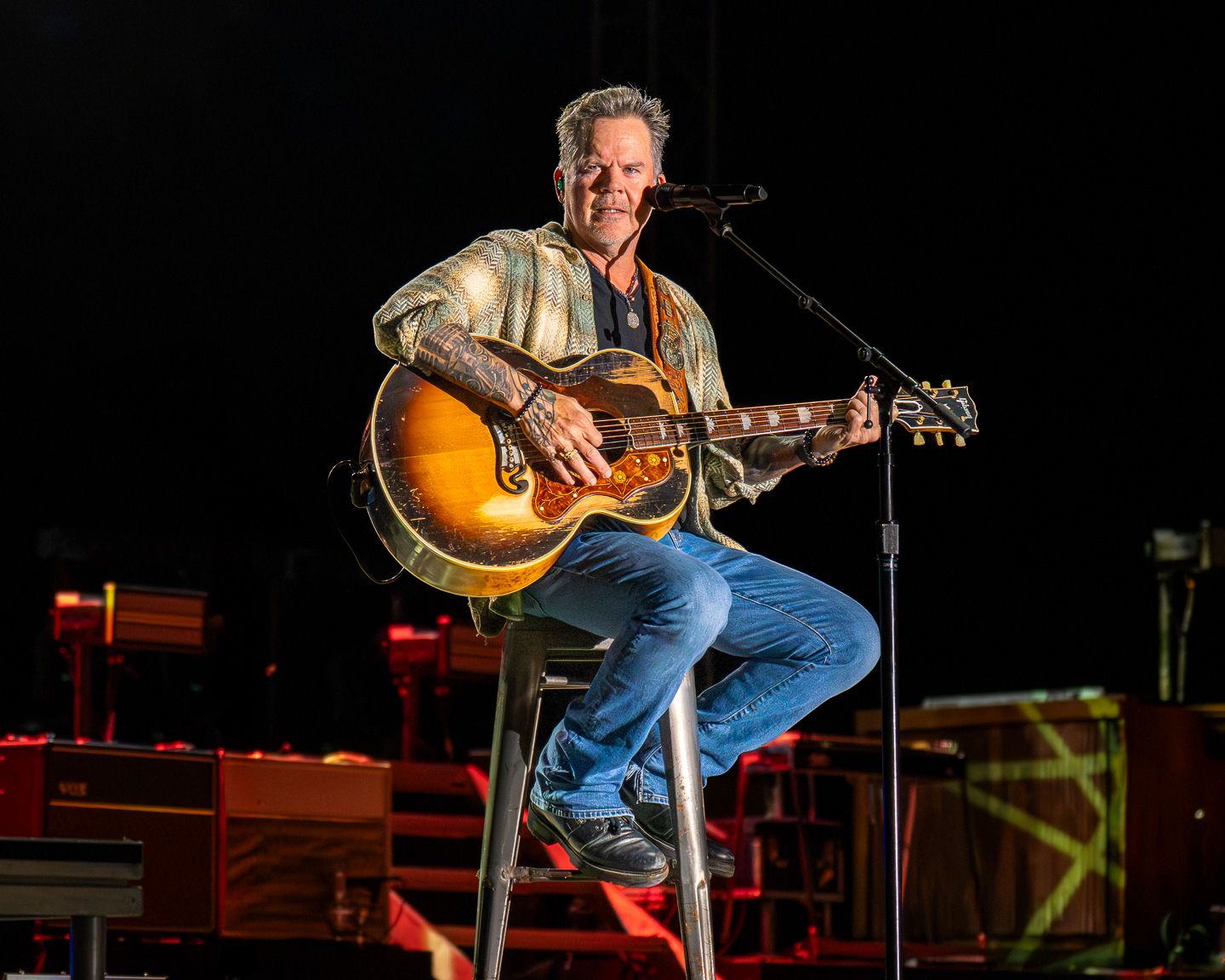 Gary Allan performing live on acoustic guitar at Round Rock Amphitheater in Round Rock, Texas.