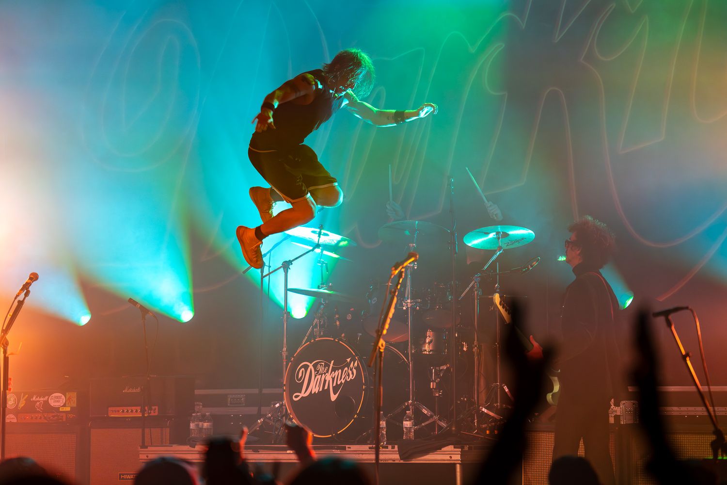 Rufus Tiger Taylor, drummer of The Darkness leaping above the stage during a live concert at Emo's Austin in Austin, Texas.
