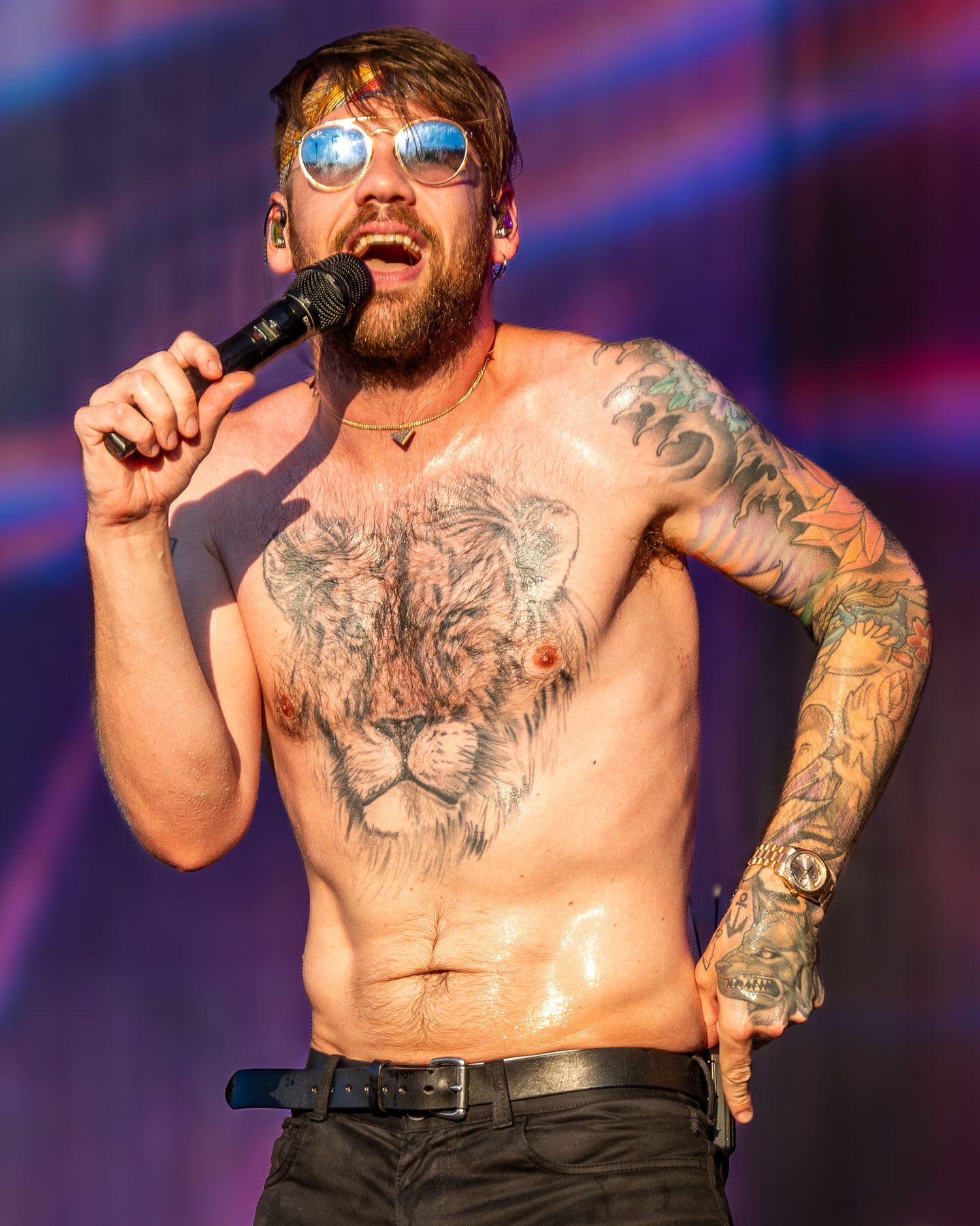 Caleb Shomo of Beartooth performing live on stage wearing mirrored sunglasses at Germania Insurance Amphitheater in Austin, Texas.