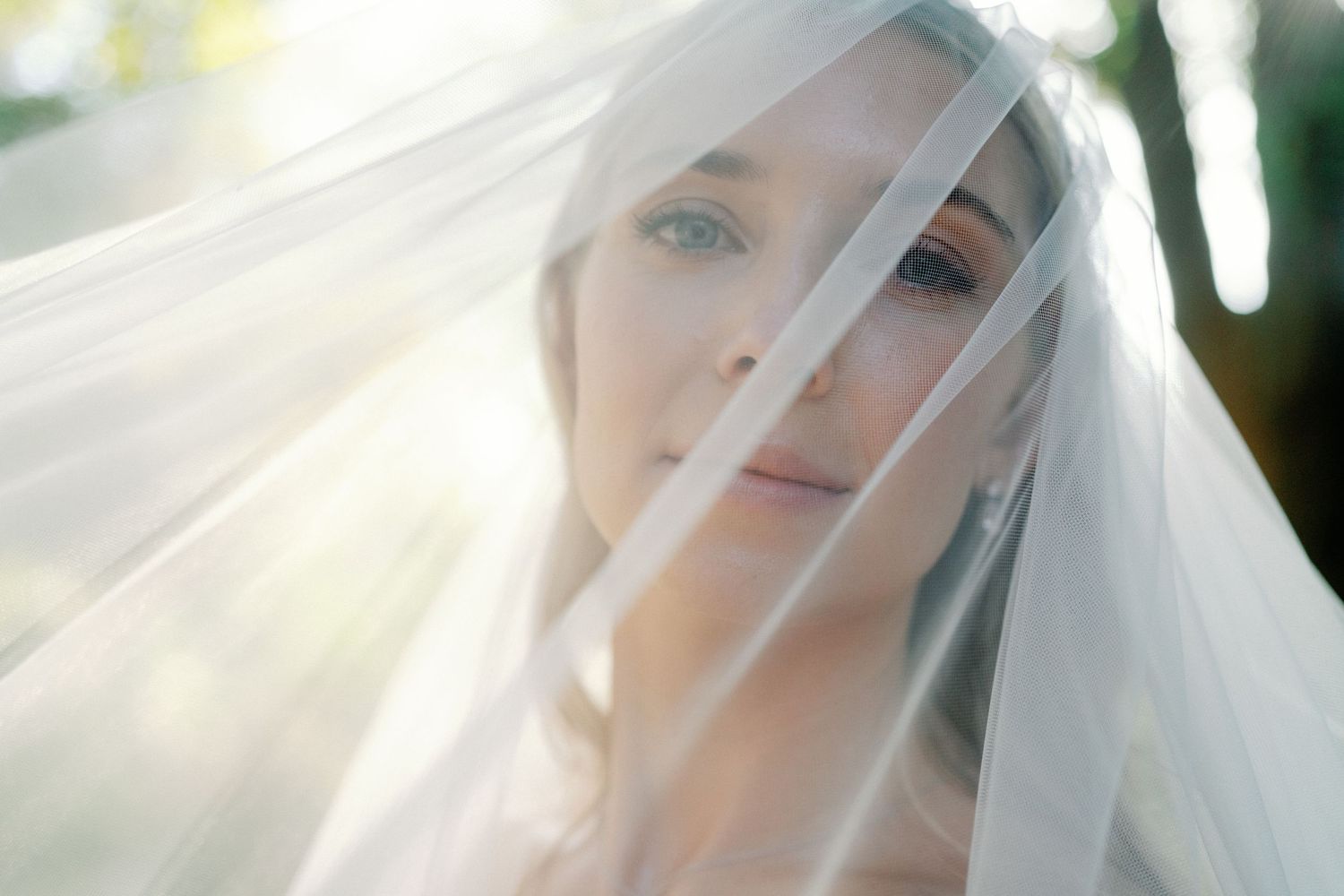 Bride beneath her veil in soft afternoon light at The Etienne Estate in Pasadena, California