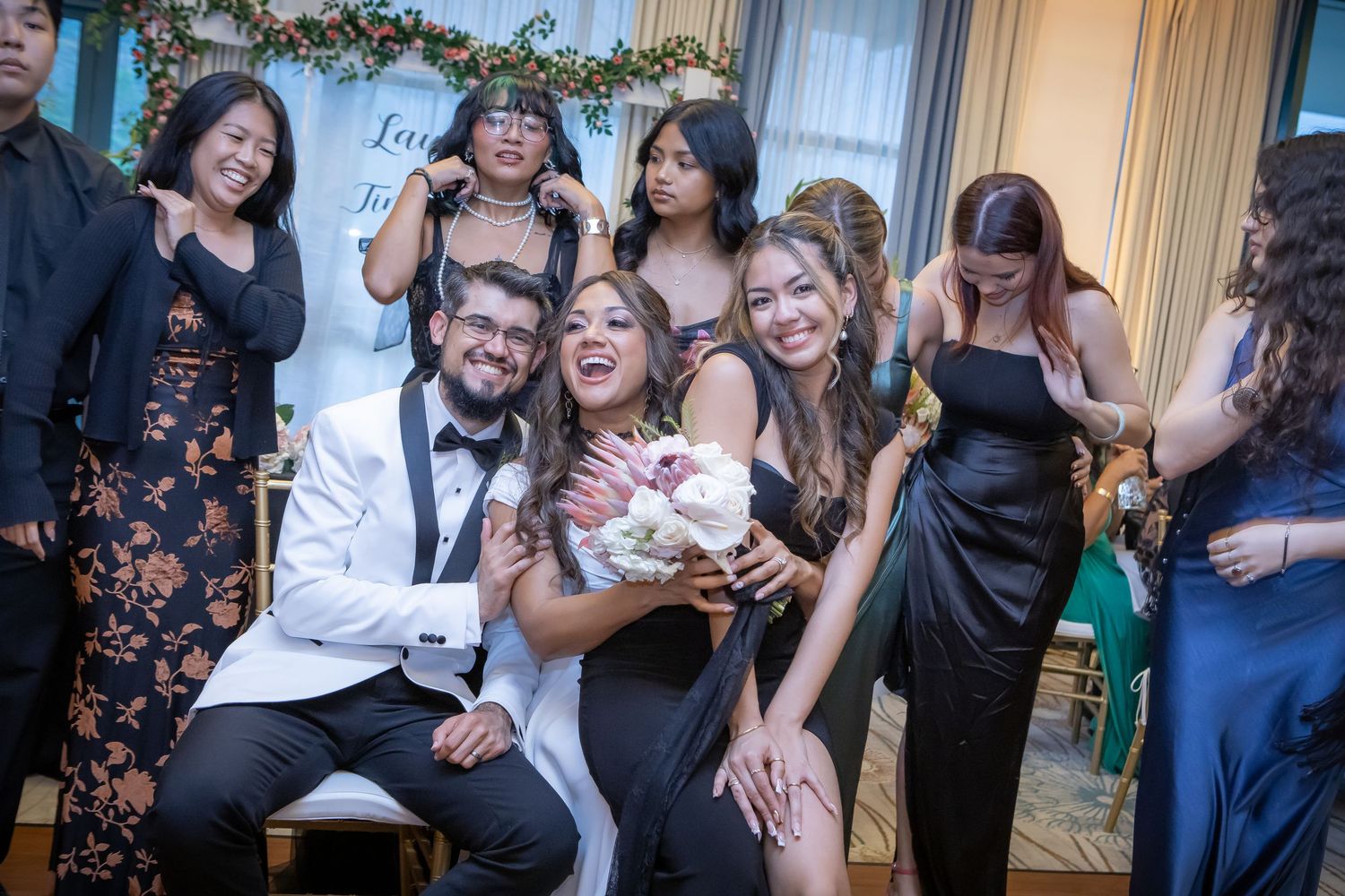 Newlyweds surrounded by family and friends during a joyful wedding celebration