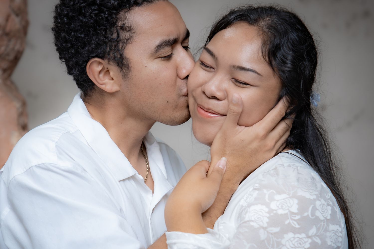 Couple sharing a tender moment during an outdoor Hawaiʻi portrait session