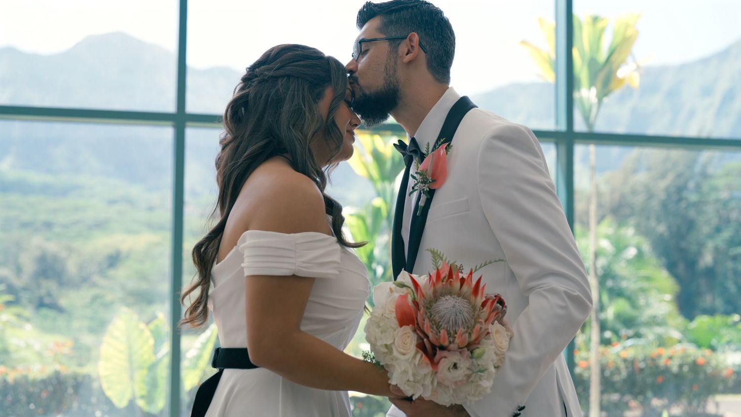 Newlyweds sharing a quiet kiss during their wedding celebration