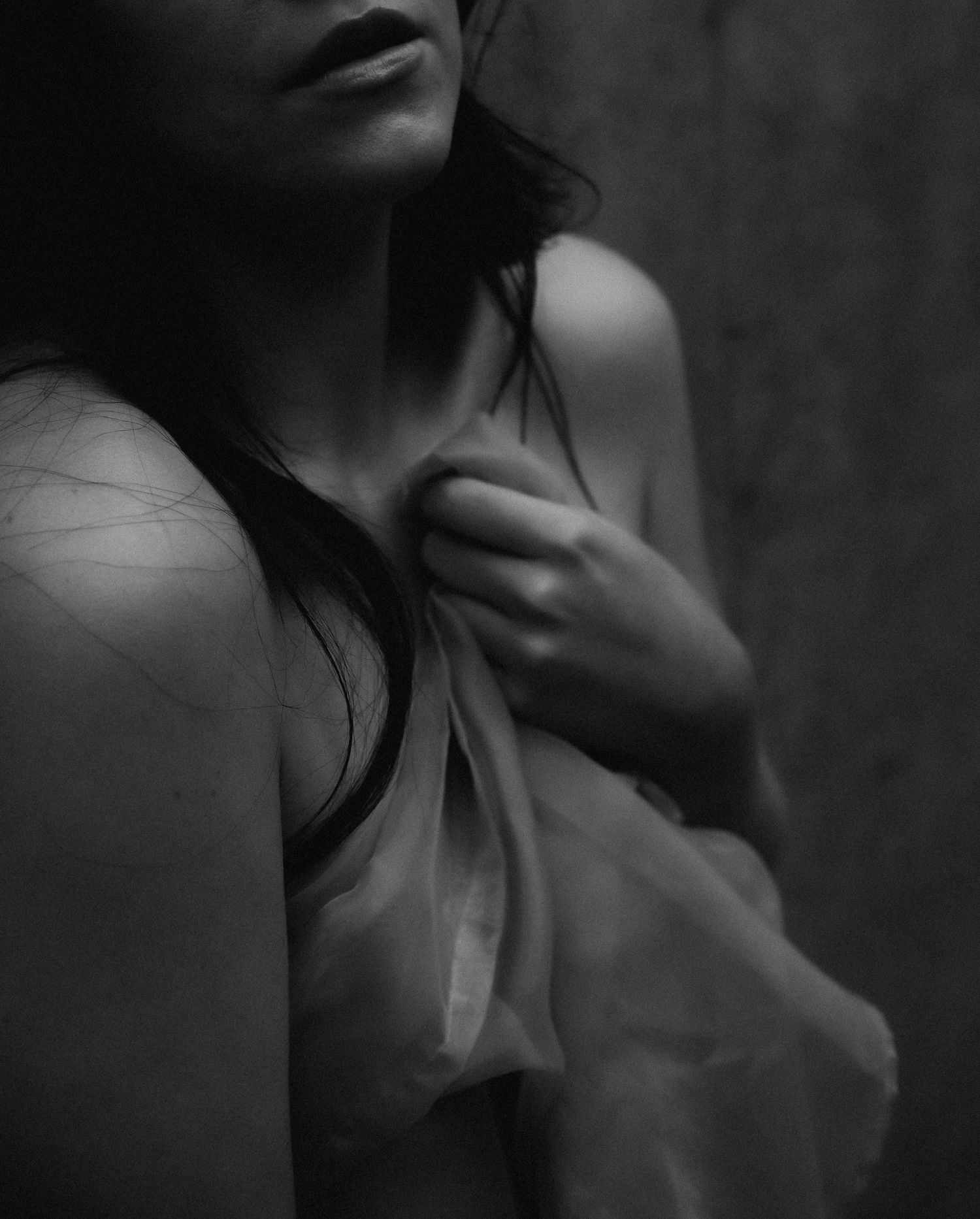 Black and white artistic photo of a woman in sheer fabric, elegant and moody fine art portrait.