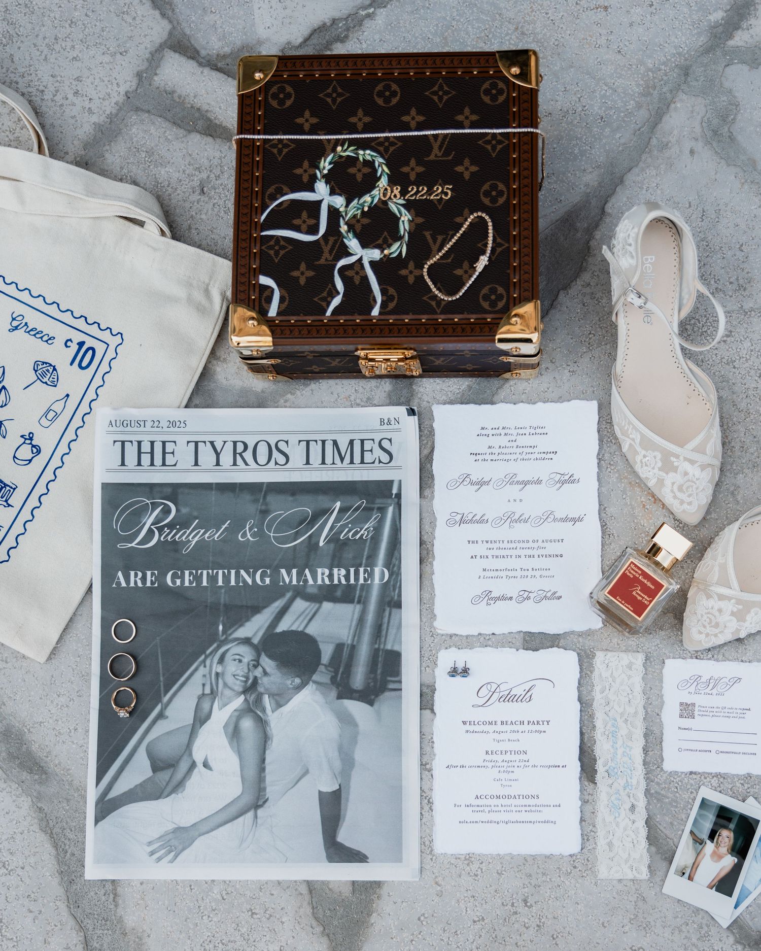 Wedding flat lay featuring invitation suite, Louis Vuitton box, lace heels, and newspaper announcement.