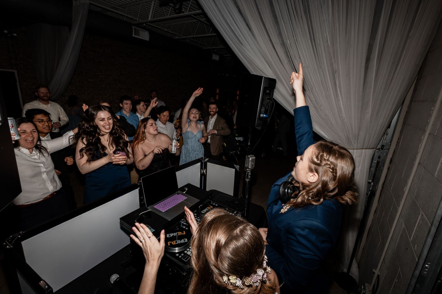 Wedding reception dance party with guests celebrating on the dance floor.