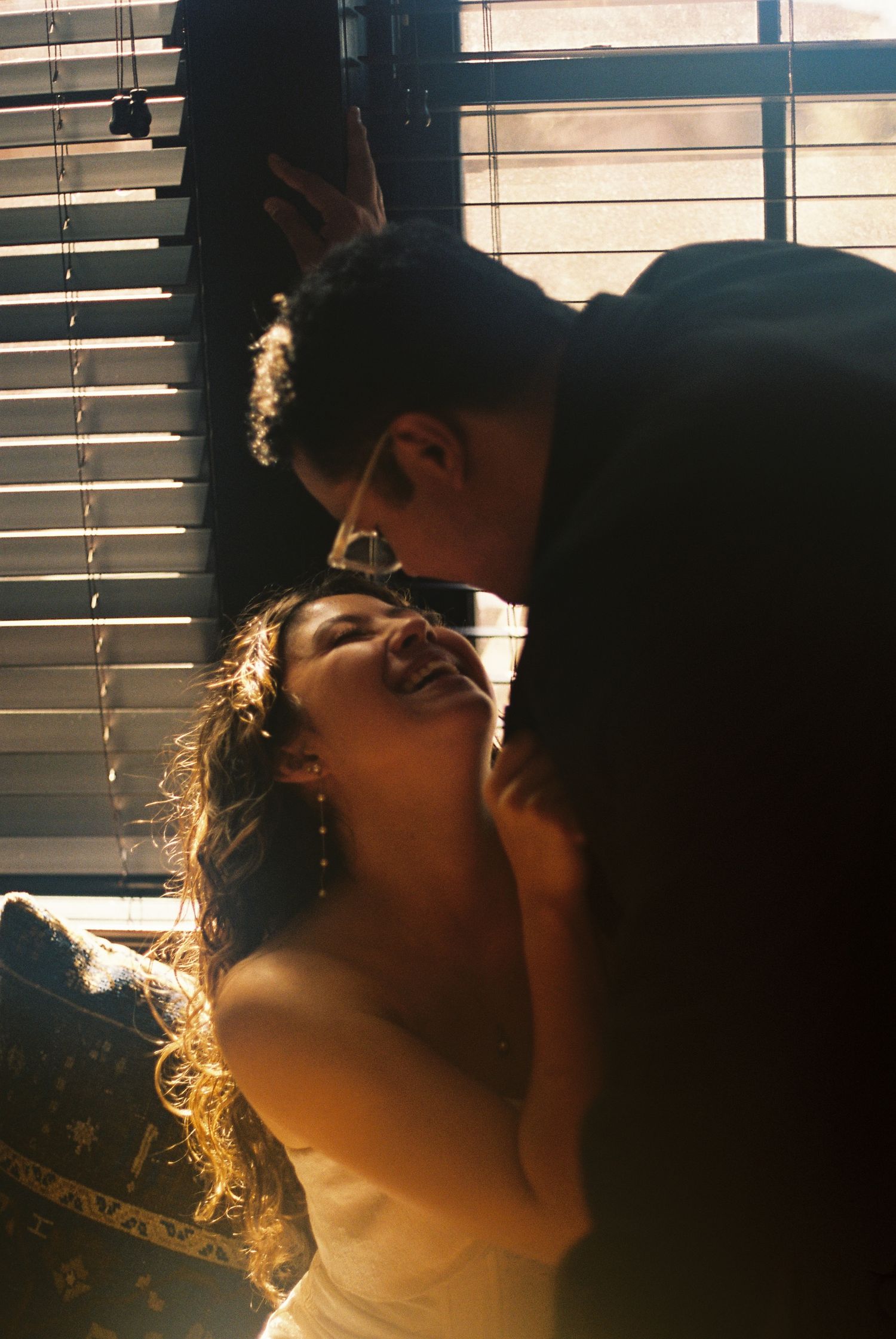 Two people in an intimate embrace, with the man leaning down towards the woman's face.