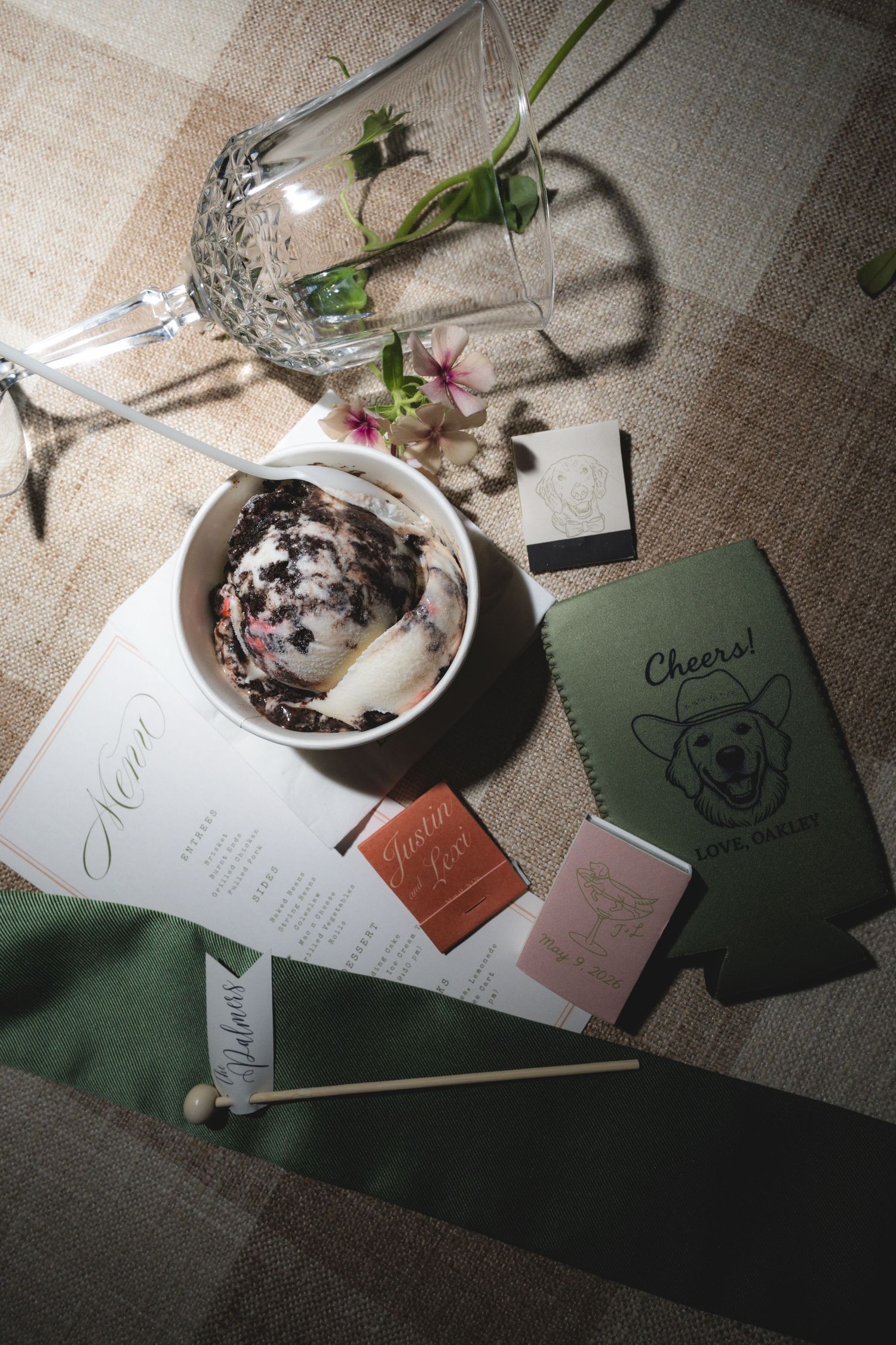 Wedding table setting with ice cream cup, menu card, and corgi-themed koozie.