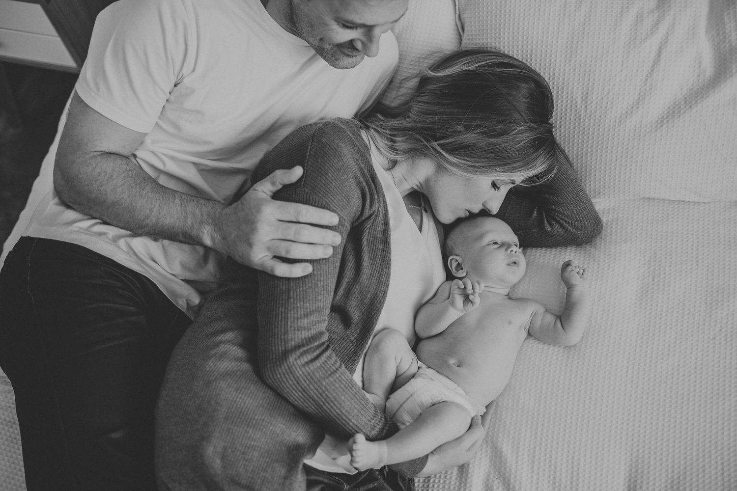 Parents watching their kids play during outdoor photo session