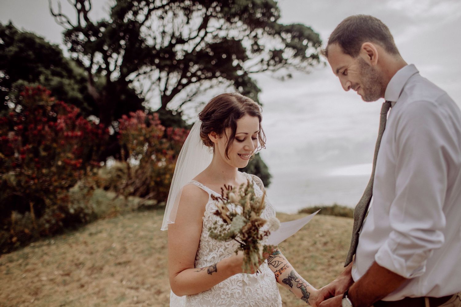 Groom wiping away tears during wedding ceremony